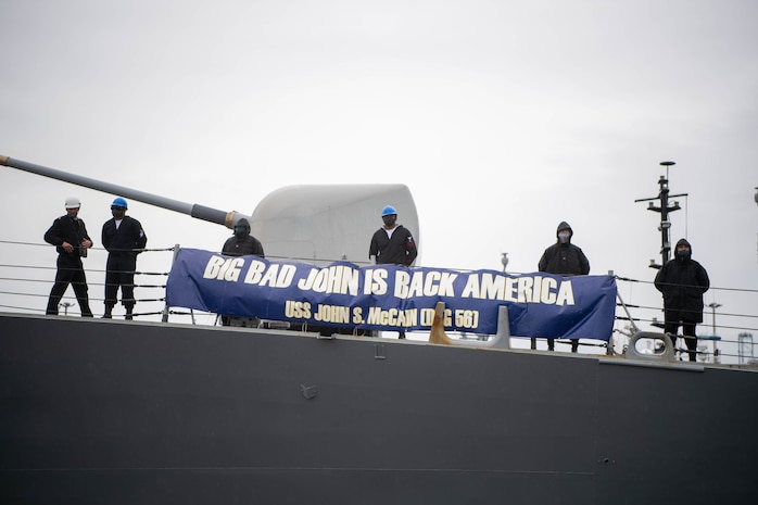 Sailors aboard the Arleigh Burke-class guided-missile destroyer USS John S. McCain (DDG 56) arrive at Naval Station Everett, Washington, its new homeport.