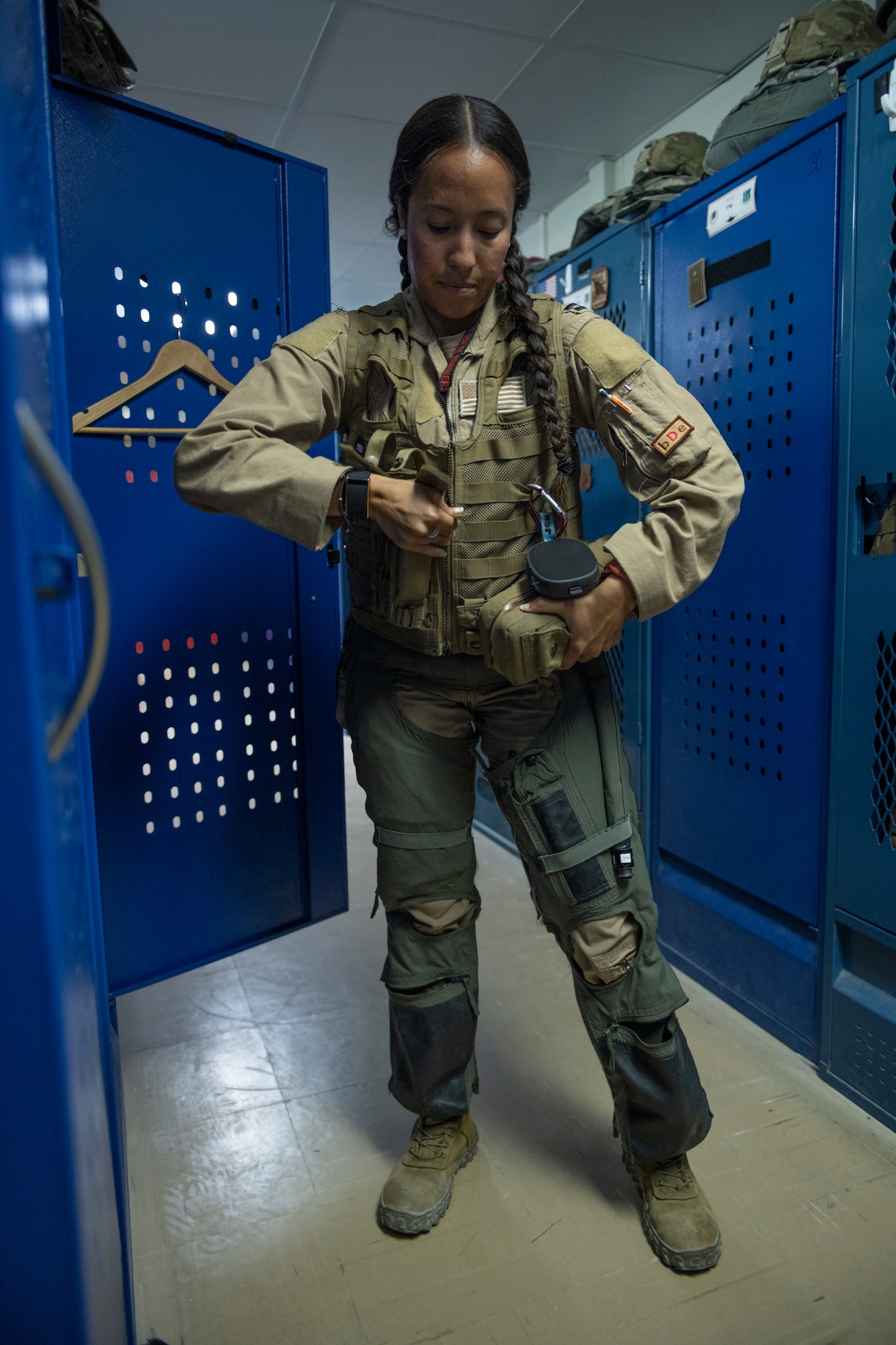 An Airman dons her flight gear