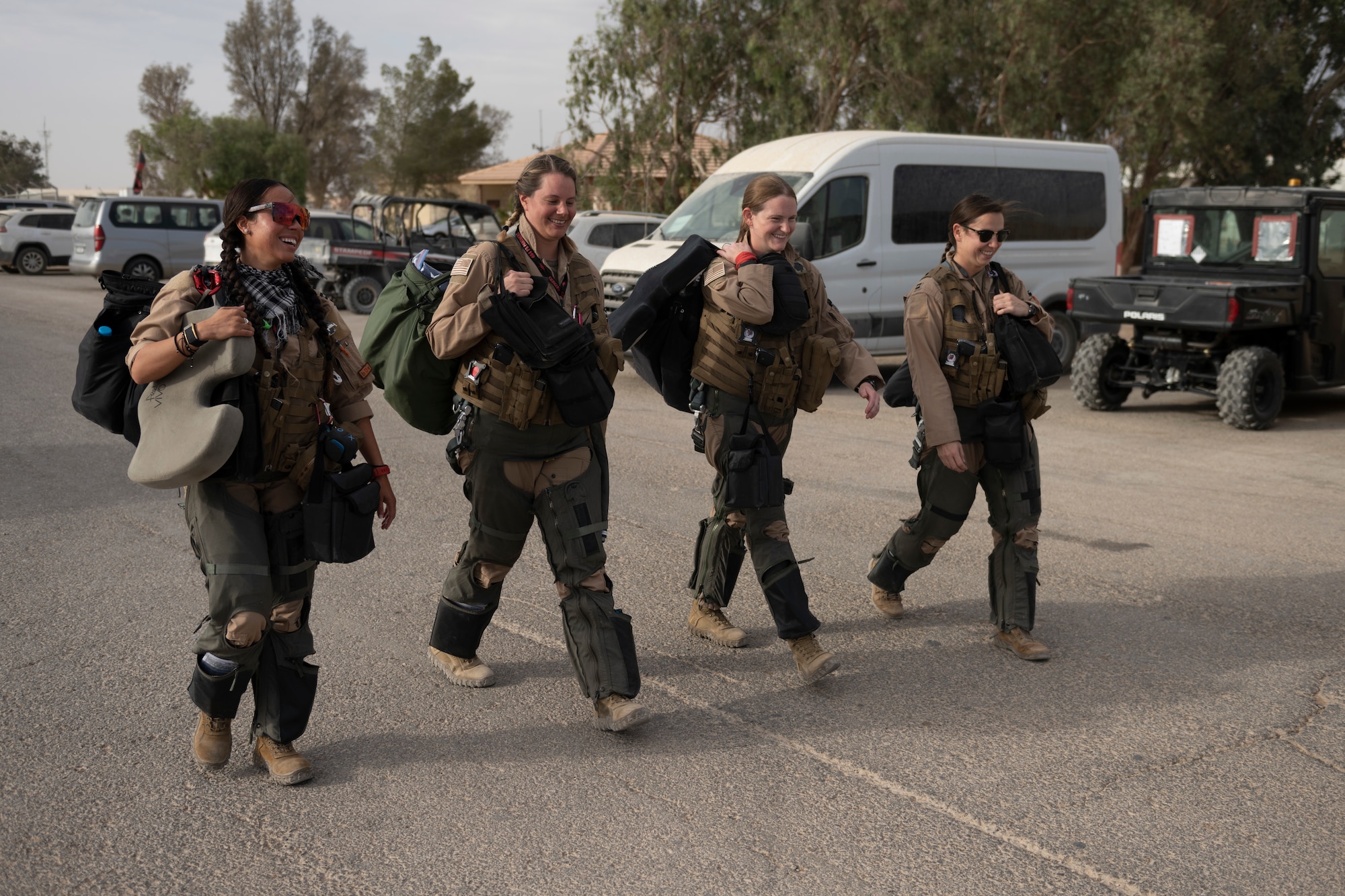 Four pilots walk to aircraft