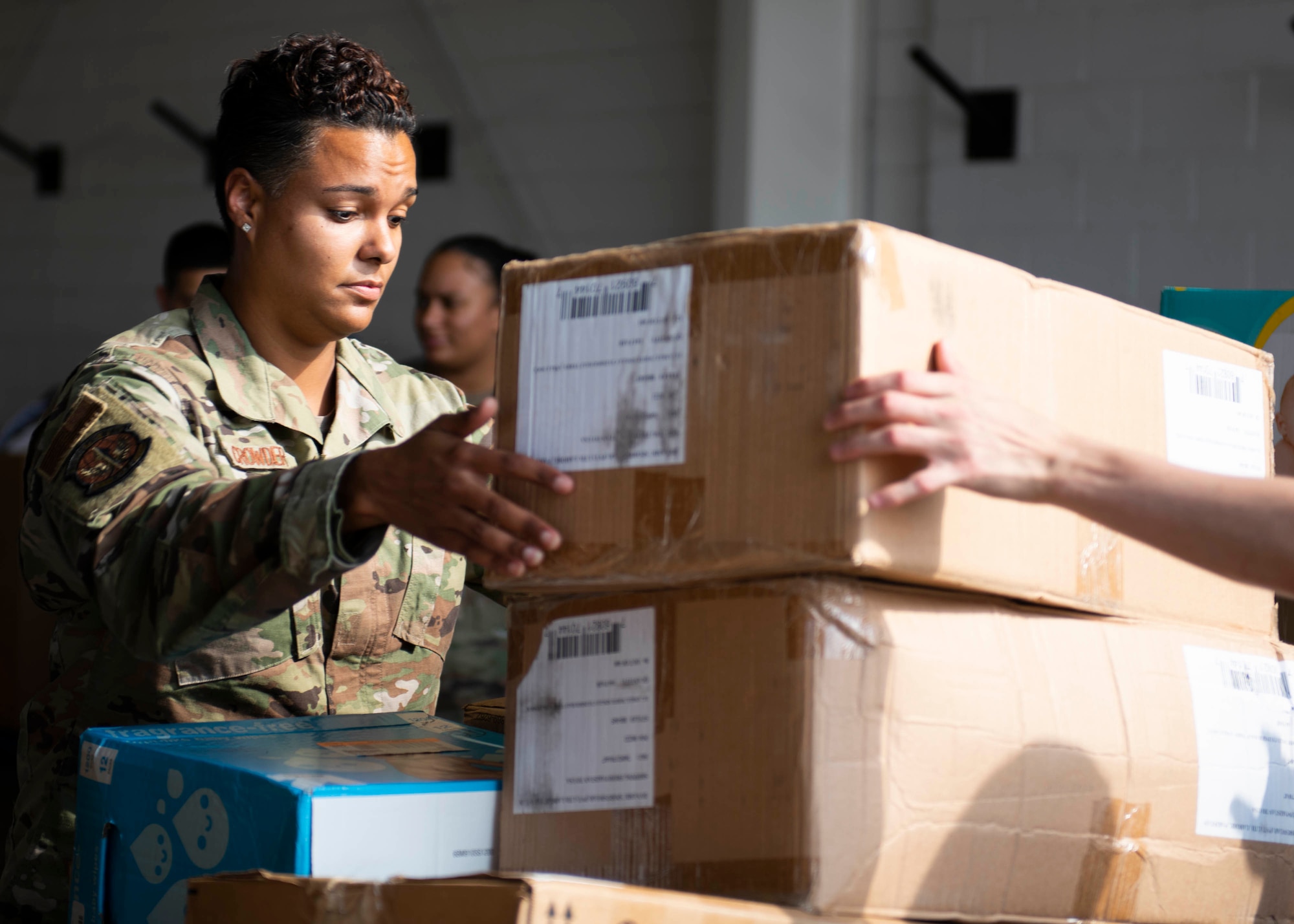 A member of Task Force Liberty unloads donated items in Liberty Village, Joint Base McGuire-Dix-Lakehurst, New Jersey, Oct. 16, 2021. The Department of Defense, through U.S. Northern Command, and in support of the Department of Homeland Security, is providing transportation, temporary housing, medical screening, and general support for at least 50,000 Afghan evacuees at suitable facilities, in permanent or temporary structures, as quickly as possible. This initiative provides Afghan personnel essential support at secure locations outside Afghanistan. (U.S. Air Force photo by Tech. Sgt. J.D. Strong II)