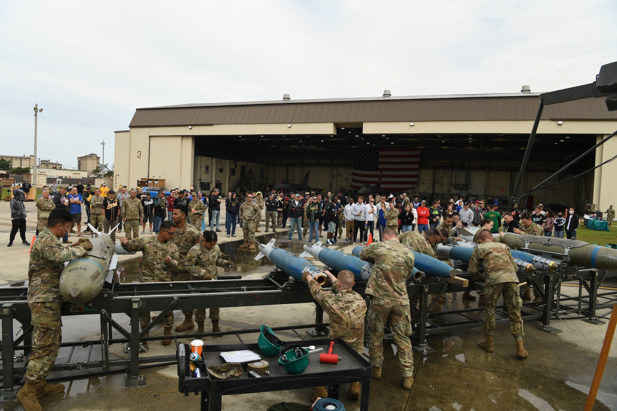 Airmen from the 8th Maintenance Squadron munitions flight build bombs during the Third Quarter Load Crew Competition at Kunsan Air Base, Republic of Korea, Oct. 16, 2021. This quarter, munitions technicians had the opportunity to compete against each other in a bomb building competition. (U.S. Air Force photo by Staff Sgt. Jesenia Landaverde)