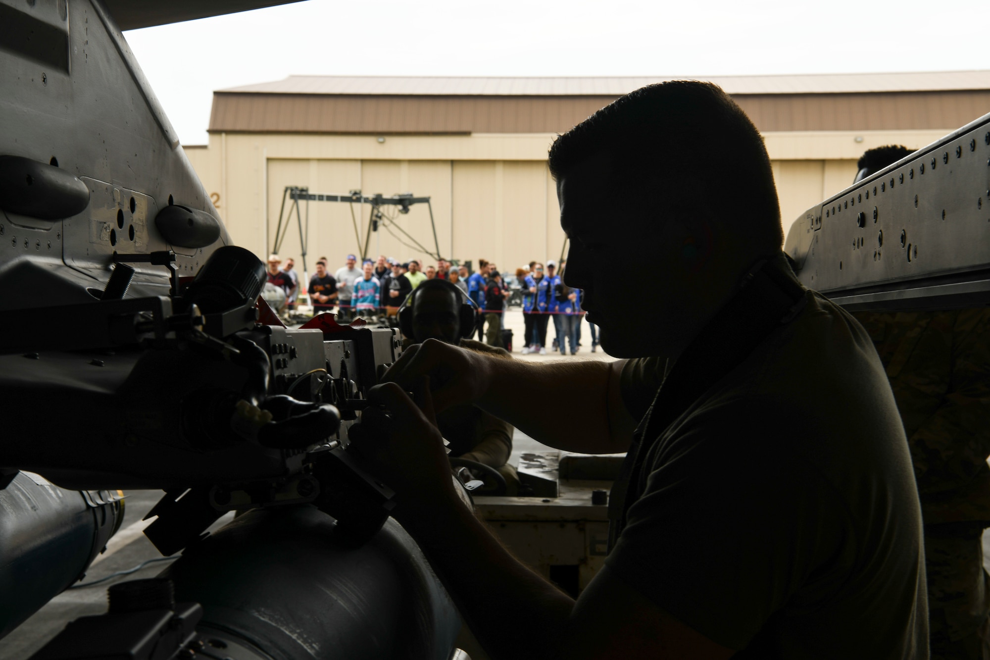 Staff Sgt. Cy Tschirgl, 35th Aircraft Maintenance Unit weapons load crew member, loads a GBU-38 onto an F-16 Fighting Falcon during the Third Quarter Load Crew Competition at Kunsan Air Base, Republic of Korea, Oct. 16, 2021. Three teams competed in four categories to include dress and appearance, a weapons knowledge test, a toolbox inspection and a weapons load. (U.S. Air Force photo by Staff Sgt. Jesenia Landaverde)