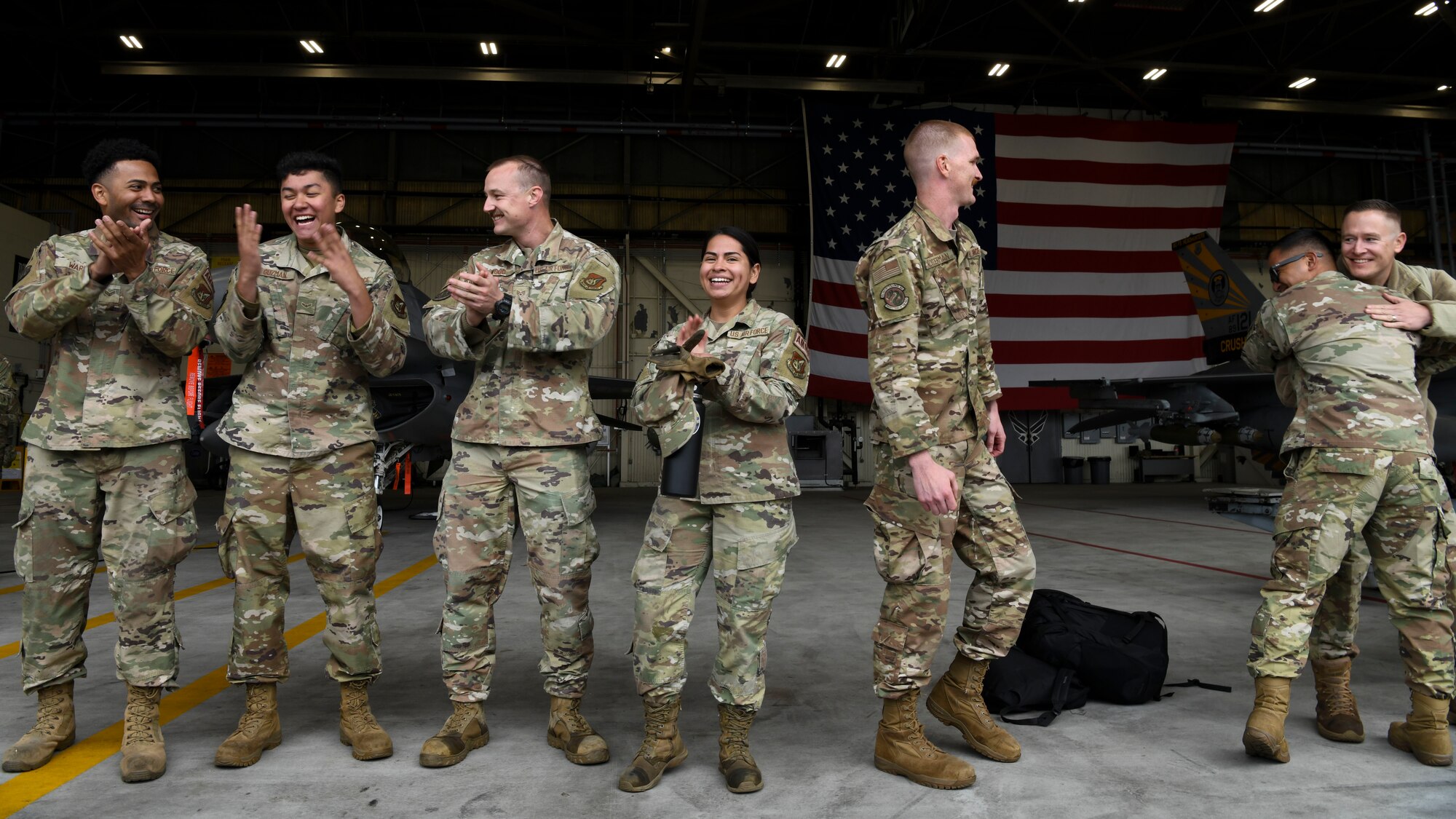 Airmen from the 8th Maintenance Squadron Munitions Flight celebrate their win during the Third Quarter Load Crew Competition at Kunsan Air Base, Republic of Korea, Oct. 16, 2021. Munitions technicians had the opportunity to compete against each other in a bomb building competition. (U.S. Air Force photo by Staff Sgt. Jesenia Landaverde)