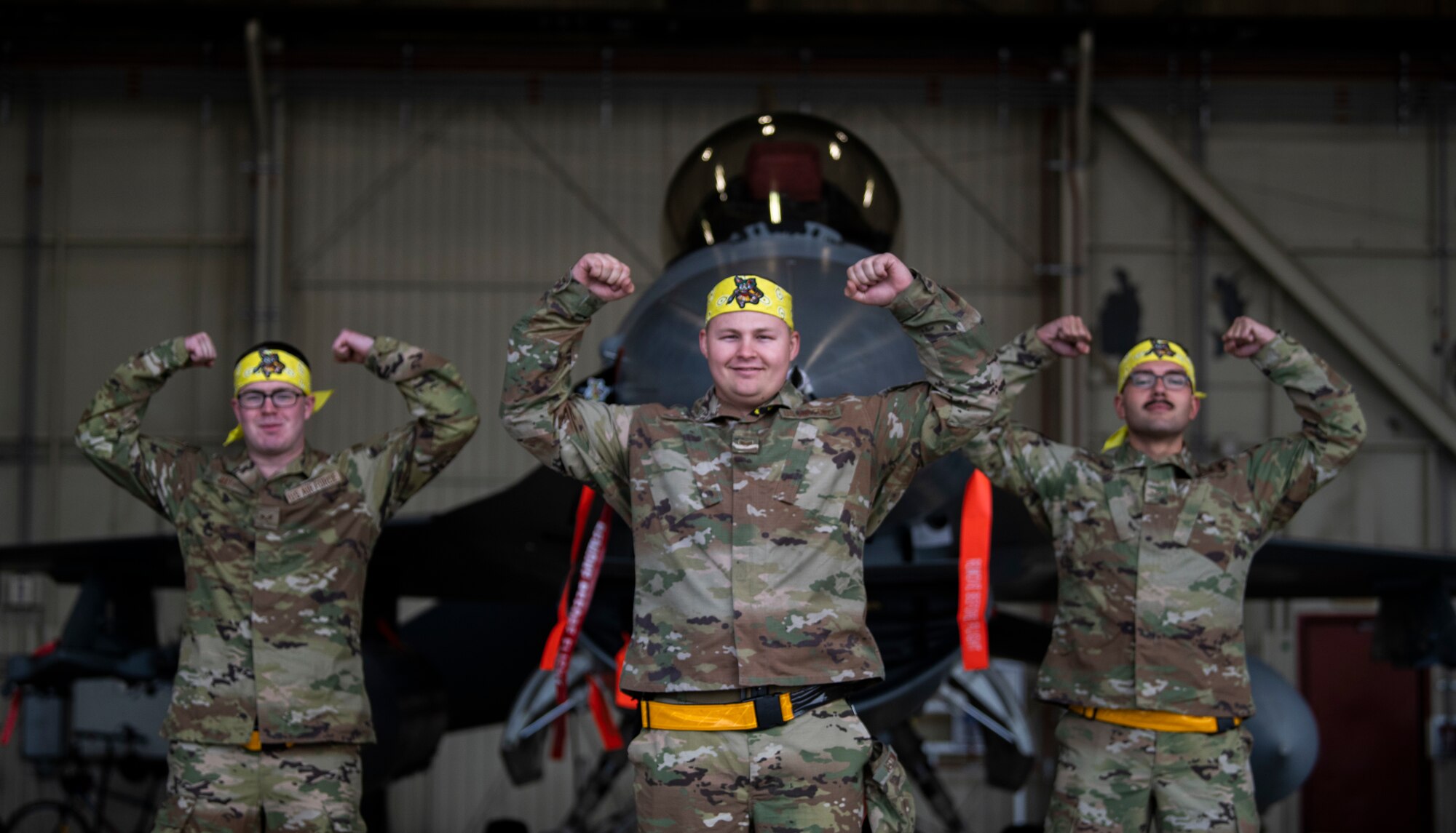 Senior Airman Cameron May, 80th Aircraft Maintenance Unit assistant dedicated crew chief, Staff Sgt. Austin Wiley, 80th AMU DCC, and Airman 1st Class Daniel Baeza, 80th AMU assistant DCC, “Crush Em” in front of an F-16 Fighting Falcon during the Third Quarter Load Crew Competition at Kunsan Air Base, Republic of Korea, Oct. 16, 2021. The DCCs were tested on their knowledge of their aircraft, skillset and professionalism. (U.S. Air Force photo by Senior Airman Suzie Plotnikov)