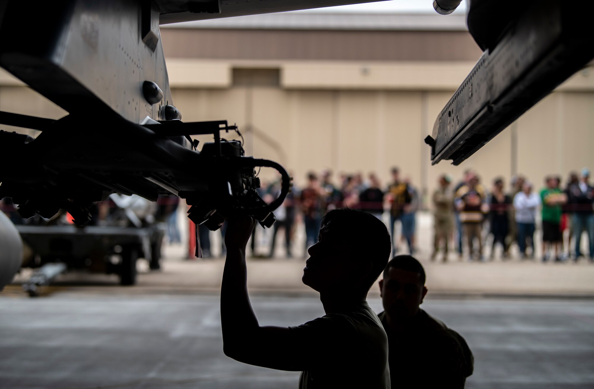 Airman Alvin Palacios, 8th Maintenance Squadron load crew team member, prepares to load munition on an F-16 Fighting Falcon during the Third Quarter Load Crew Competition at Kunsan Air Base, Republic of Korea, Oct. 16, 2021. Three teams competed in four categories to include dress and appearance, a weapons knowledge test, a toolbox inspection and a weapons load. (U.S. Air Force photo by Senior Airman Suzie Plotnikov)