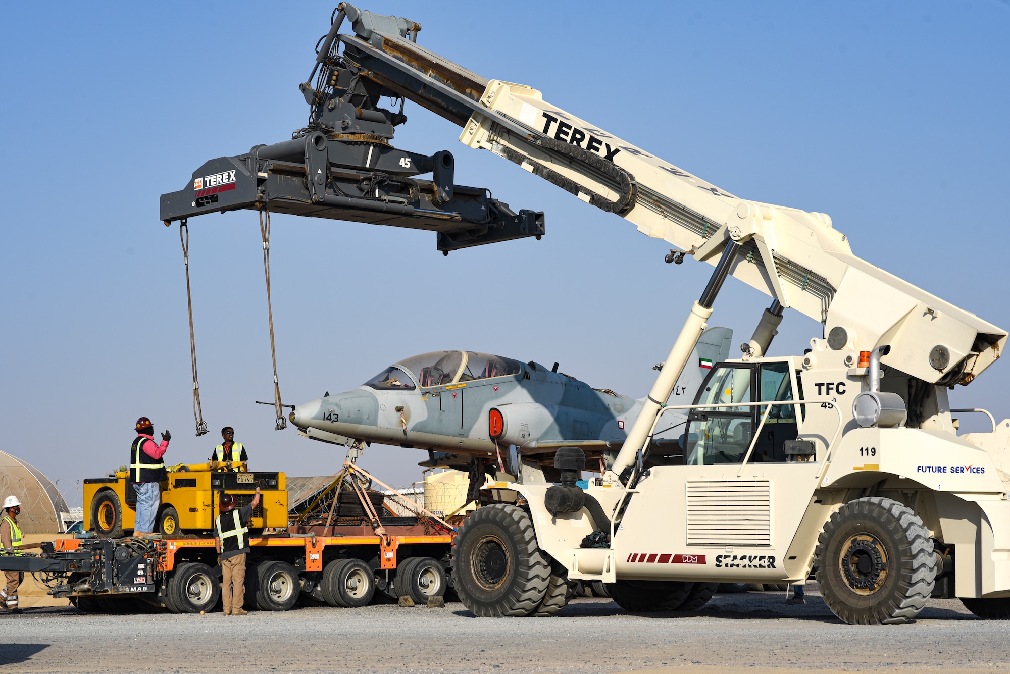 Multi-national forces lift a Kuwait Air Force Hawk aircraft is lifted to clear a gate on Ali Al Salem Air Base, Kuwait, Oct. 15, 2021.