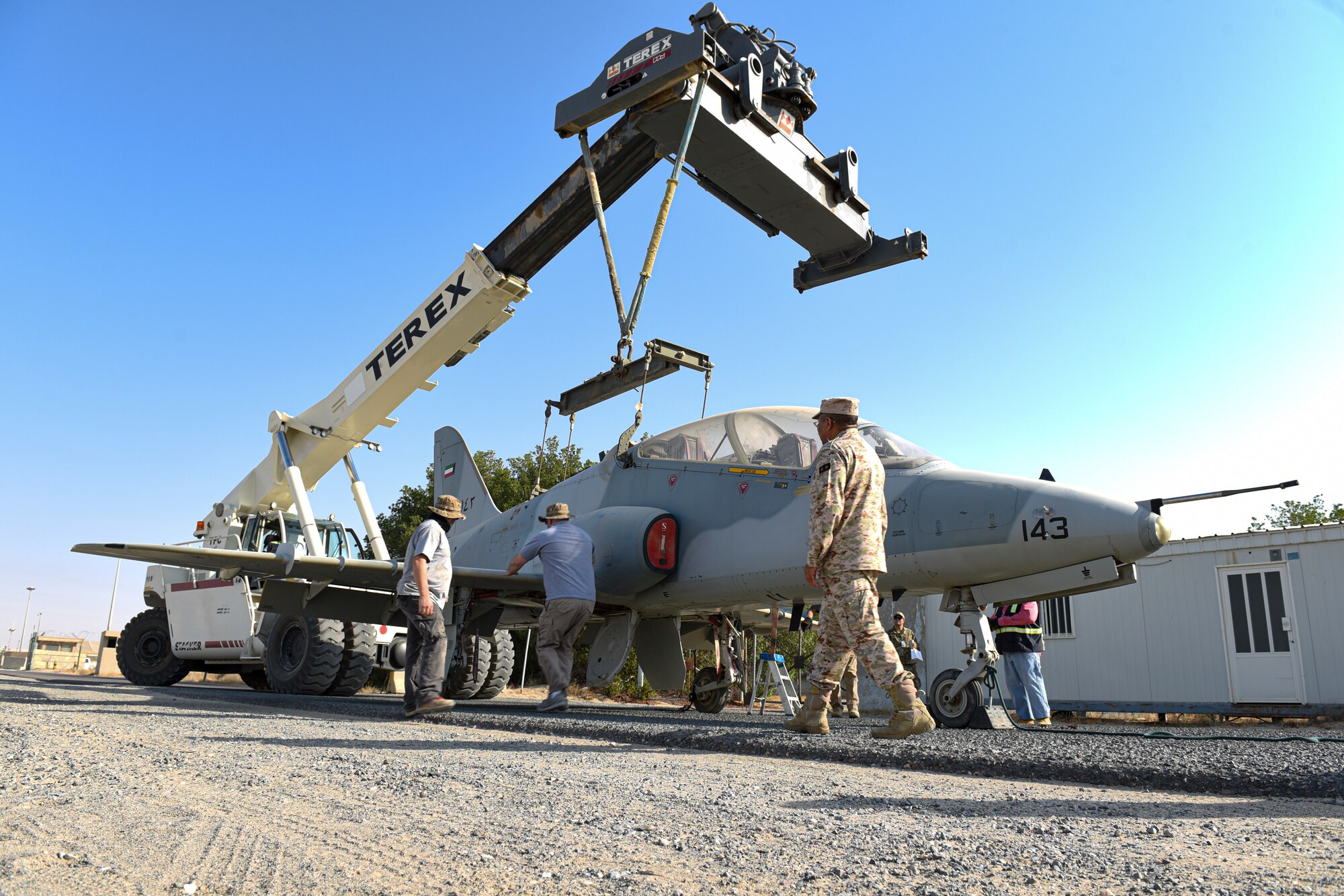 Multi-national forces lift a Kuwait Air Force Hawk aircraft to clear a gate on Ali Al Salem Air Base, Kuwait, Oct. 15, 2021.