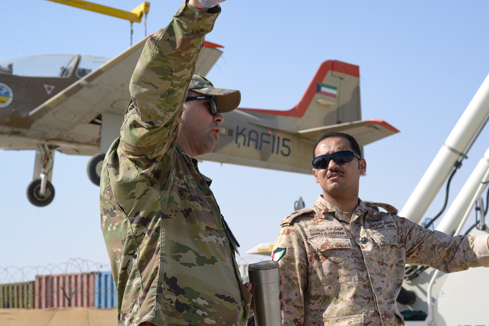 U.S. Air Force Capt. José Barreto, 386th Expeditionary Logistics Readiness Squadron director of operations, and Kuwait Air Force Lt. Col. Hamad Ghanim Zahzeeh, SO2 Maintenance Squadron 32, coordinate the logistics of a joint ground movement of Kuwait air force aircrafts between Al Mubarak Air Base, Kuwait,  and Ali Al Salem Air Base, Kuwait from Oct, 15, 2021.