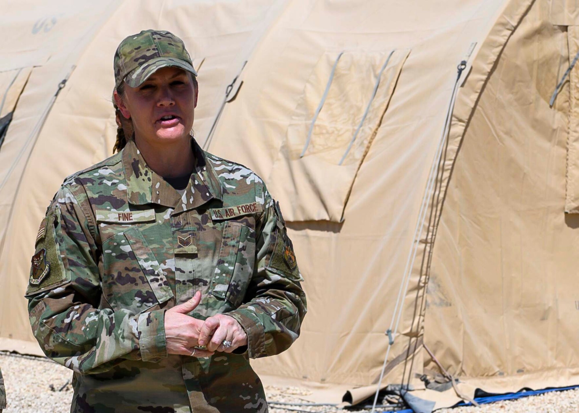 U.S. Air Force Staff Sgt. Allison Fine, 378th Air Expeditionary Wing military justice noncommissioned officer–in-charge, delivers a speech during the ribbon cutting of the U.S. Serve-Us Members Attic, Prince Sultan Air Base, Kingdom of Saudi Arabia, Sept. 11 2021. The attic acts as an organized donation center open around-the-clock for gently-used items and was started by an all-volunteer team led by Fine, modeled after the concept of an Airman’s Attic found on most Air Force bases. Joint members leaving PSAB are now able to donate unneeded items prior to departure while new members can acquire needed items for free, saving money and reducing the amount of waste produced at PSAB. (U.S. Air Force photo by Senior Airman Samuel Earick)