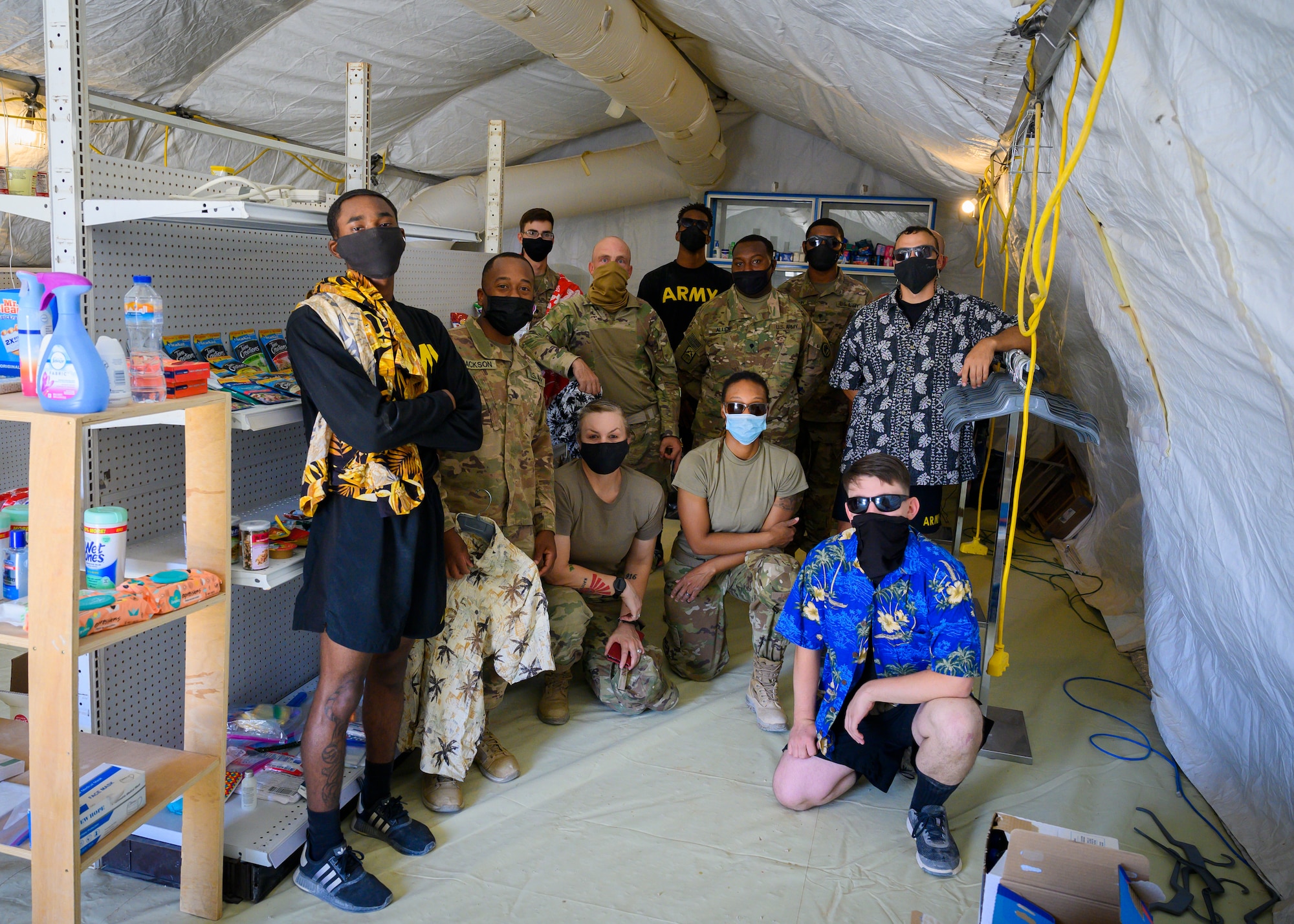 U.S service members deployed to Prince Sultan Air Base, Kingdom of Saudi Arabia, pose for a photo after putting together the U.S. Serve-Us members Attic,  Sept. 11 2021. The attic acts as an organized donation center open around-the-clock for gently-used items and was started by an all-volunteer team, modeled after the concept of an Airman’s Attic found on most Air Force bases. Joint members leaving PSAB are now able to donate unneeded items prior to departure while new members can acquire needed items for free, saving money and reducing the amount of waste produced at PSAB. (U.S. Air Force photo by Senior Airman Samuel Earick)