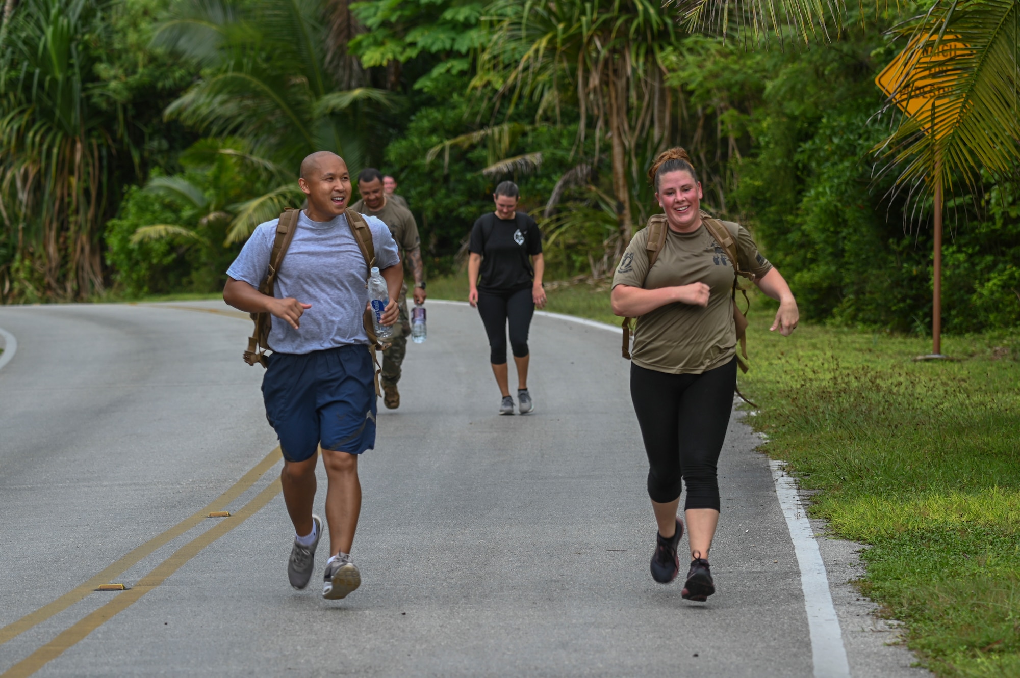Airmen running down a hill.