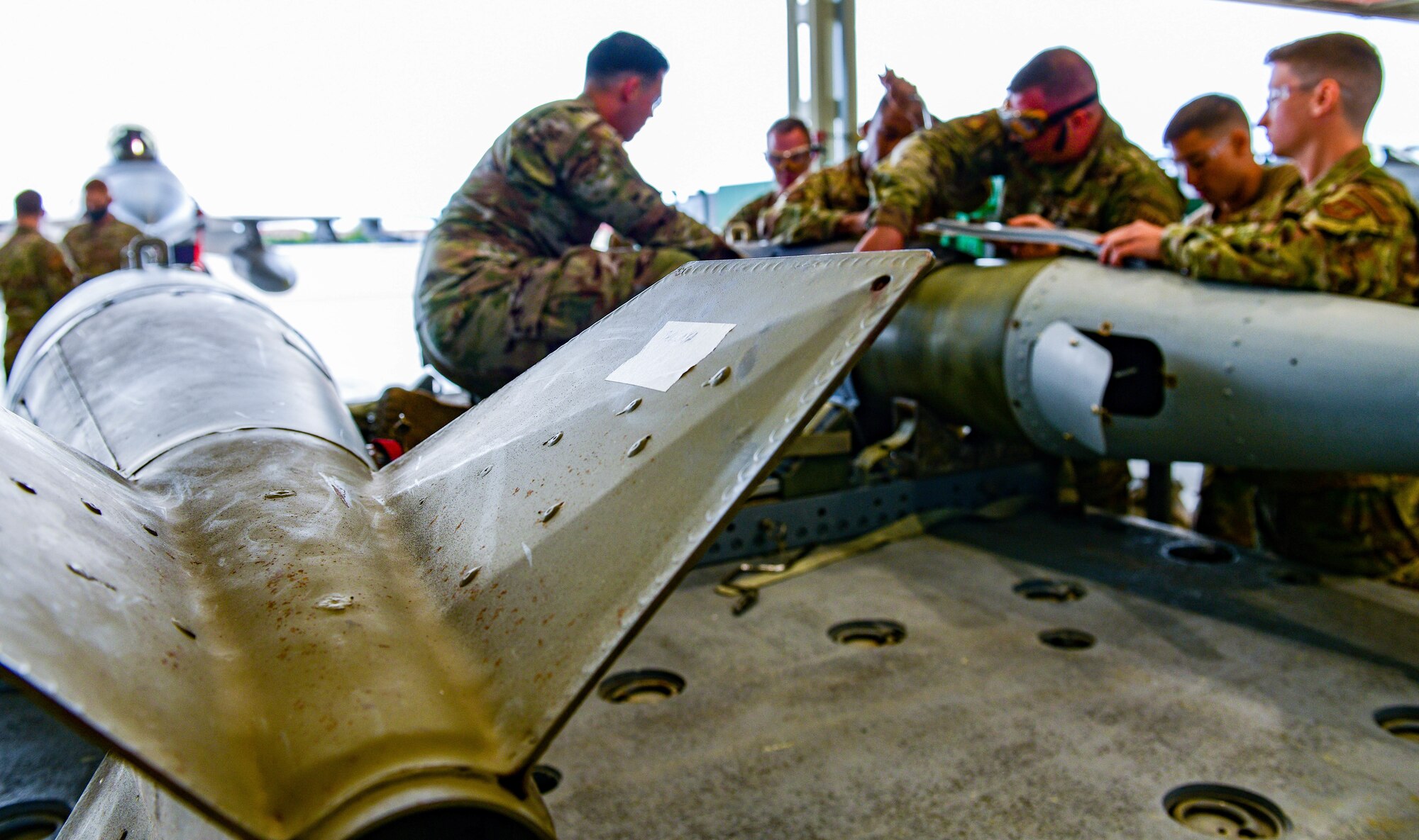 U.S. Airmen assigned to the 31st Munitions Squadron build an inert munition during the 3rd quarter Rapid Aircraft Generation and Employment (RAGE) event at Aviano Air Base, Italy, Oct. 7, 2021. RAGE showcases Aviano’s lethal combat capabilities and prove Agile Combat Employment (ACE) effectiveness through demonstrations and competitions. (U.S. Air Force photo by Senior Airman Brooke Moeder)