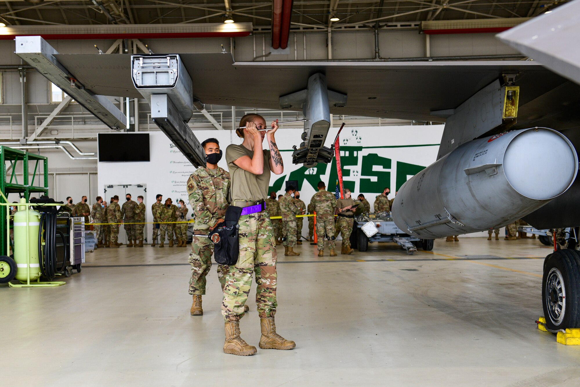 Airman 1st Class Gillian Metzger, 510th Aircraft Maintenance Unit weapons load crew member, prepares an F-16 Fighting Falcon to be loaded with munitions during the 3rd quarter Rapid Aircraft Generation and Employment (RAGE) event at Aviano Air Base, Italy, Oct. 7, 2021. The weapons load crews competed head-to-head to see which team could perform the most effective and reliable load in the shortest amount of time. (U.S. Air Force photo by Senior Airman Brooke Moeder)