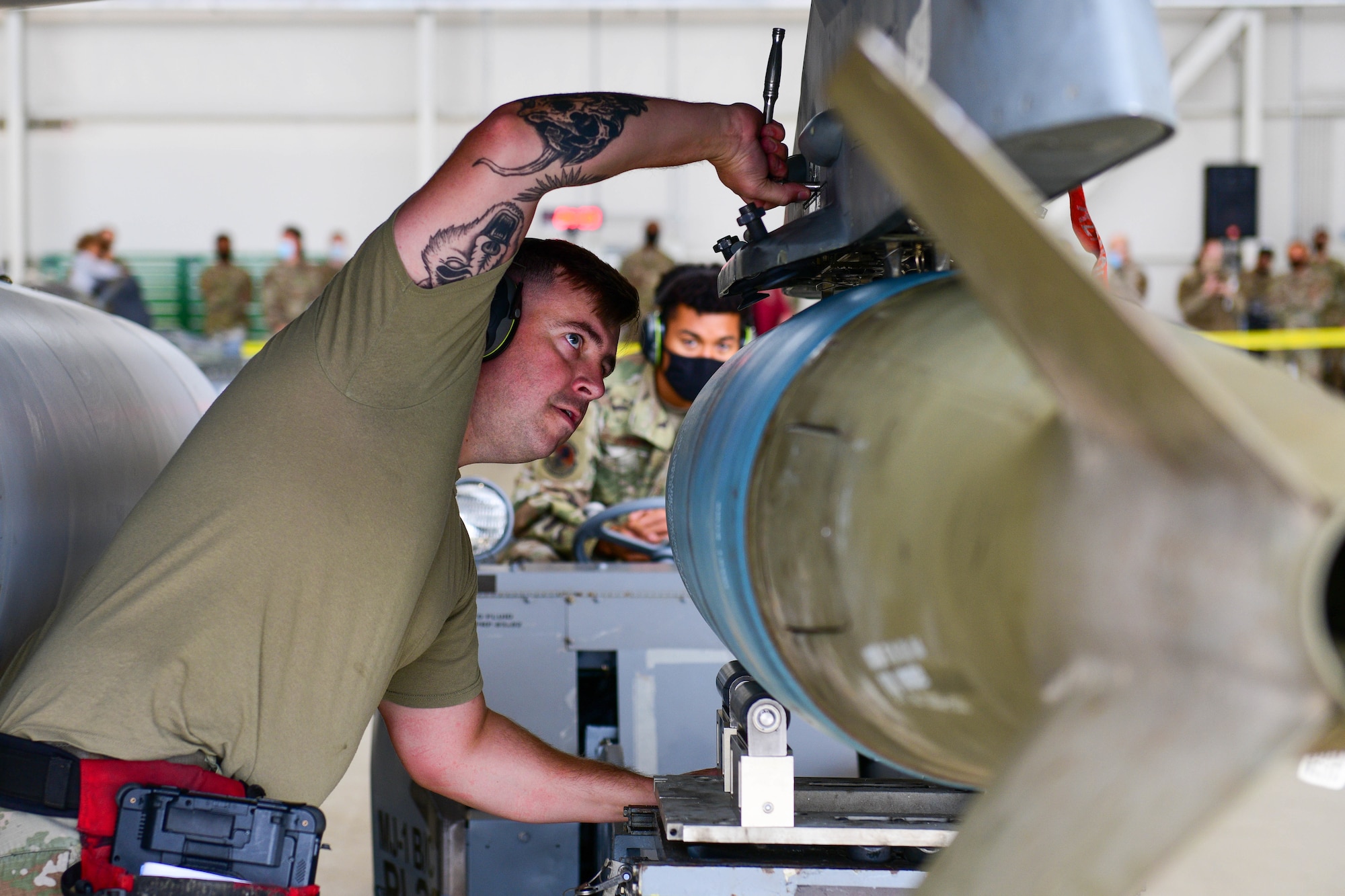 An Airman assigned to the 31st Maintenance Group loads an inert munition onto an F-16 Fighting Falcon during the 3rd quarter Rapid Aircraft Generation and Employment (RAGE) event at Aviano Air Base, Italy, Oct. 7, 2021. During RAGE, instructors evaluated the teams on technical proficiency, safety procedures and overall time. (U.S. Air Force photo by Senior Airman Brooke Moeder)