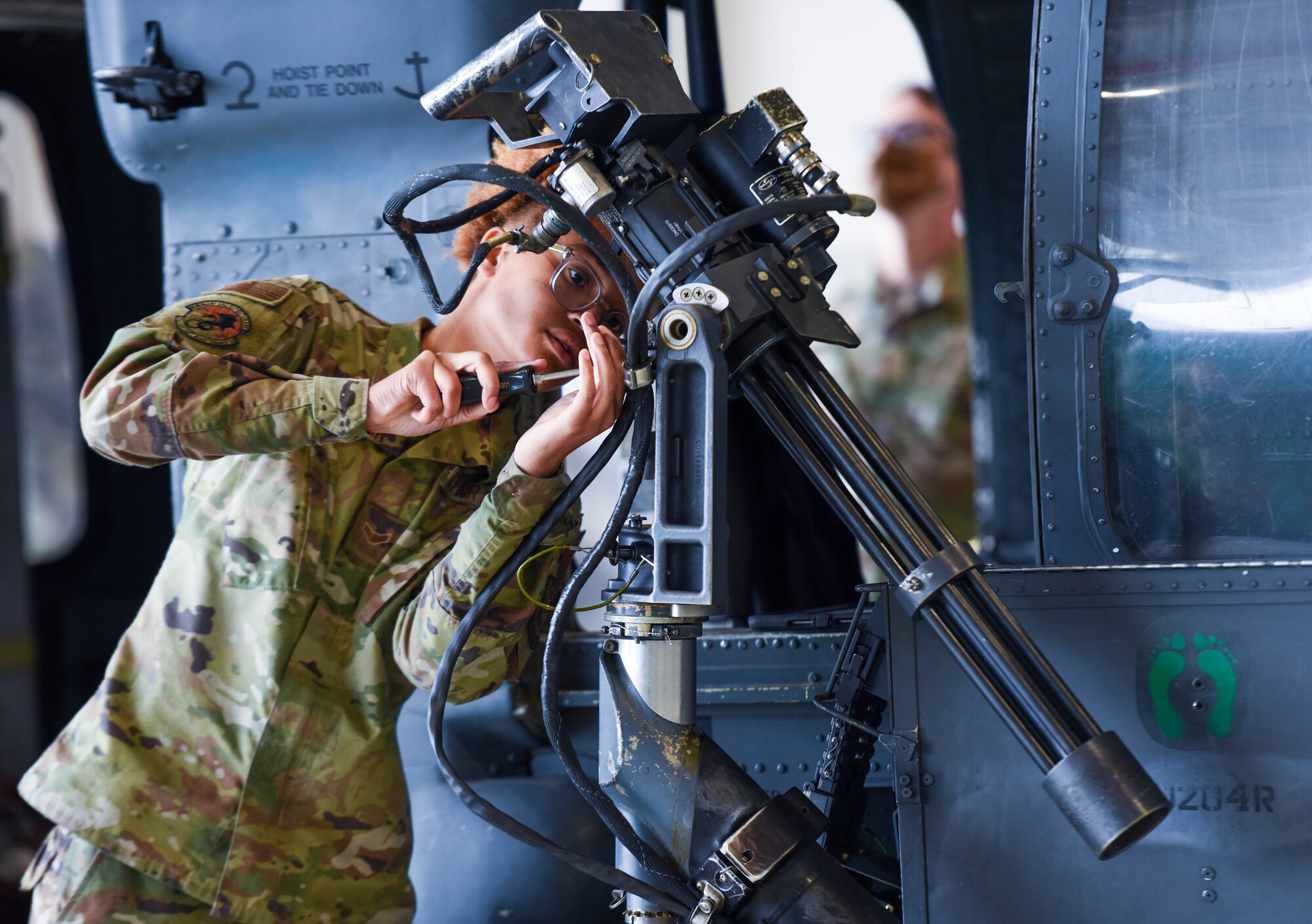 Airman 1st Class Dajea Harrison, 31st Aircraft Maintenance Squadron weapons load crew member, assembles a .50-caliber gun system on an HH-60G Pave Hawk during the 3rd quarter Rapid Aircraft Generation and Employment (RAGE) event at Aviano Air Base, Italy, Oct. 7, 2021. During RAGE, a team completed an unfolding of an HH-60G helicopter while simultaneously installing one GAU-18 .50 caliber machine gun and one GAU-1 minigun in a coordinated effort. (U.S. Air Force photo by Senior Airman Brooke Moeder)