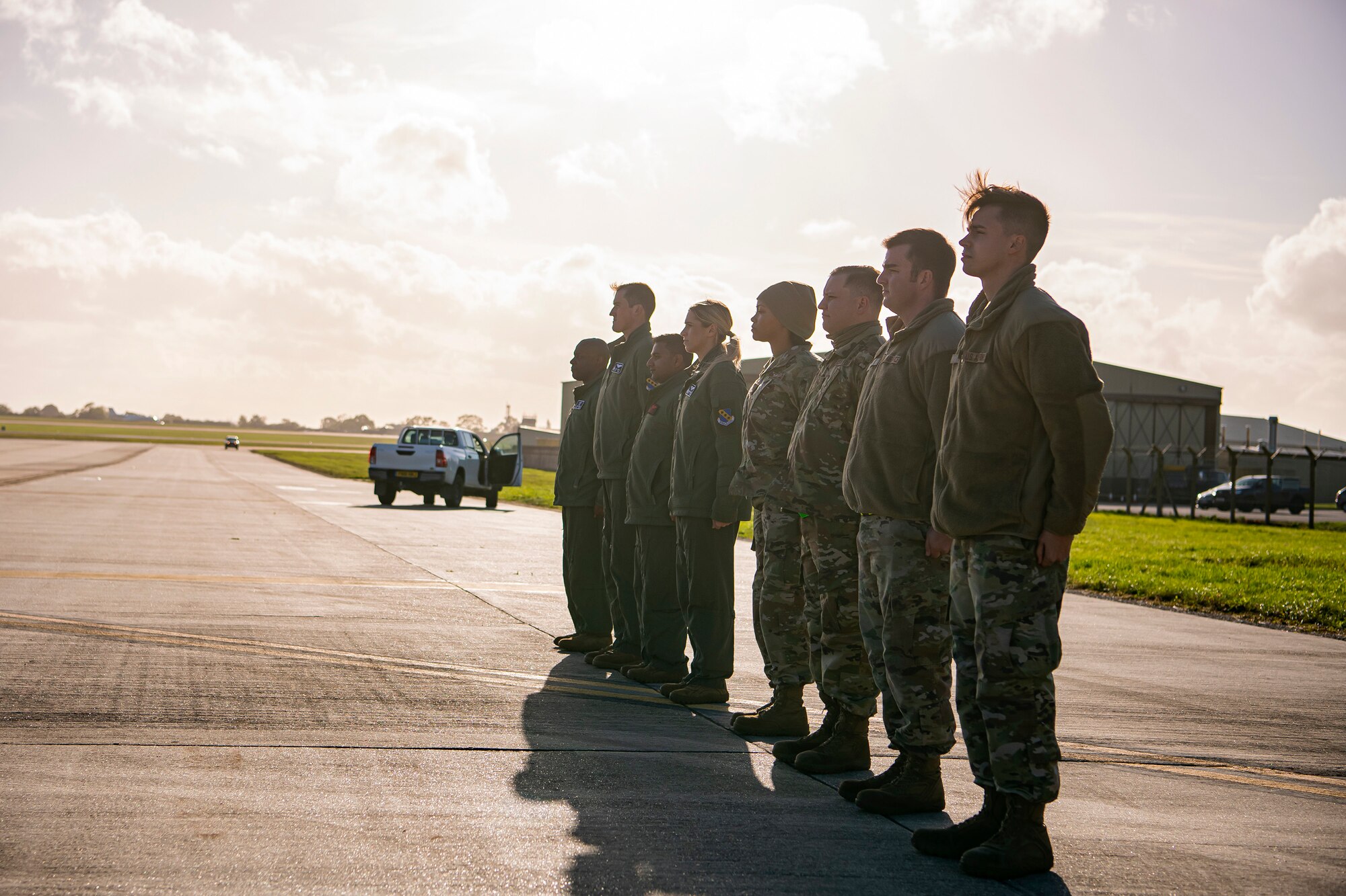 Airmen from the 9th Expeditionary Bomb Squadron stand at attention prior to meeting distinguished visitors at RAF Fairford, England, Oct. 20, 2021. Airmen from the 9th EBS are temporarily stationed at Fairford for a Bomber Task Force deployment. The Department of Defense maintains command and control of its bomber force for any mission, any time, anywhere in the world. (U.S. Air Force photo by Senior Airman Eugene Oliver)
