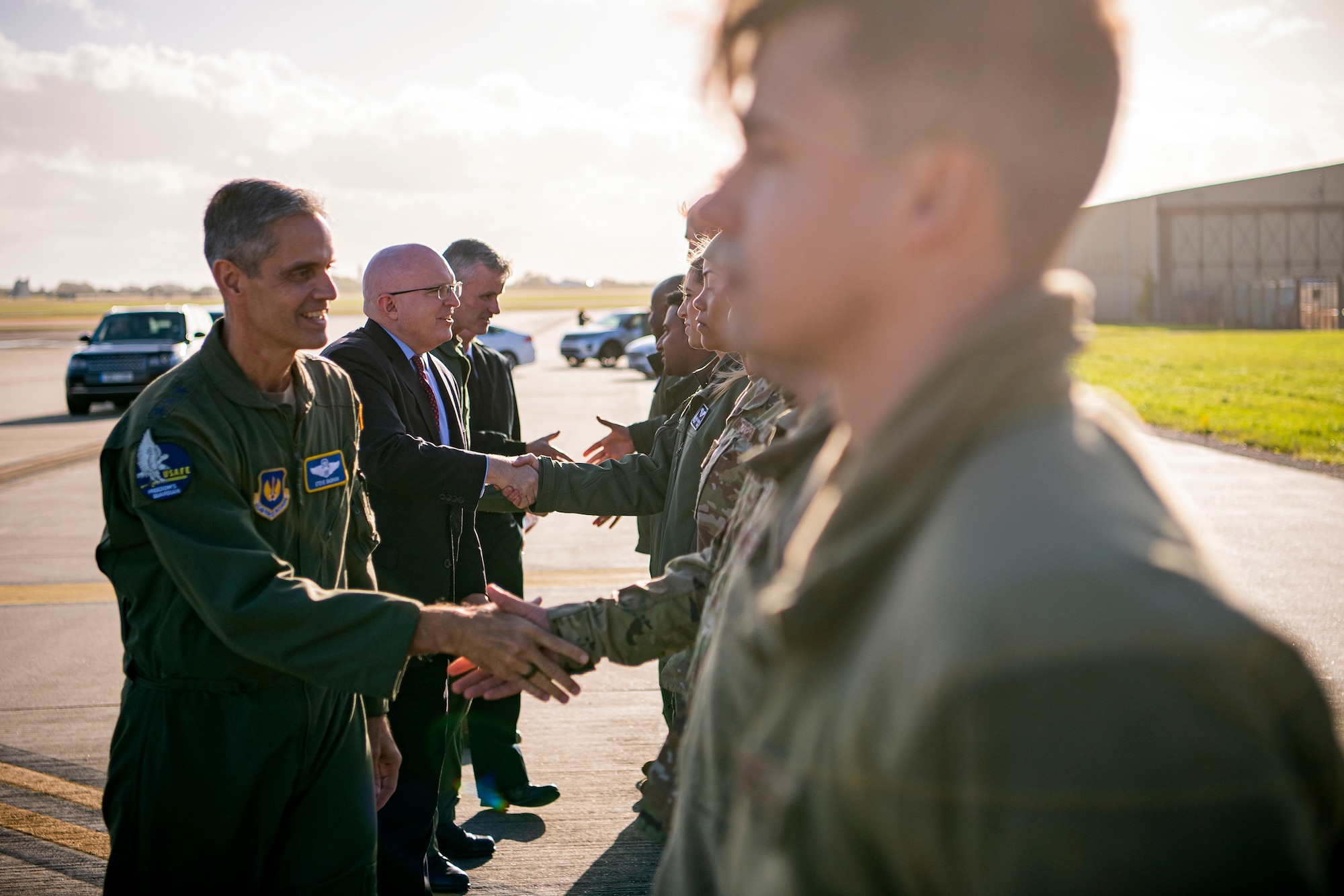 Distinguished visitors, left, shake hands with Airmen from the 9th Expeditionary Bomb Squadron, prior to a Bomber Task Force press conference at RAF Fairford, England, Oct. 20, 2021. Airmen from the 9th EBS are temporarily stationed at RAF Fairford as part of a BTF deployment. A BTF is the global employment of U.S. strategic bombers, which provide a strategic military advantage to achieve national and combatant commander objectives. (U.S. Air Force photo by Senior Airman Eugene Oliver)