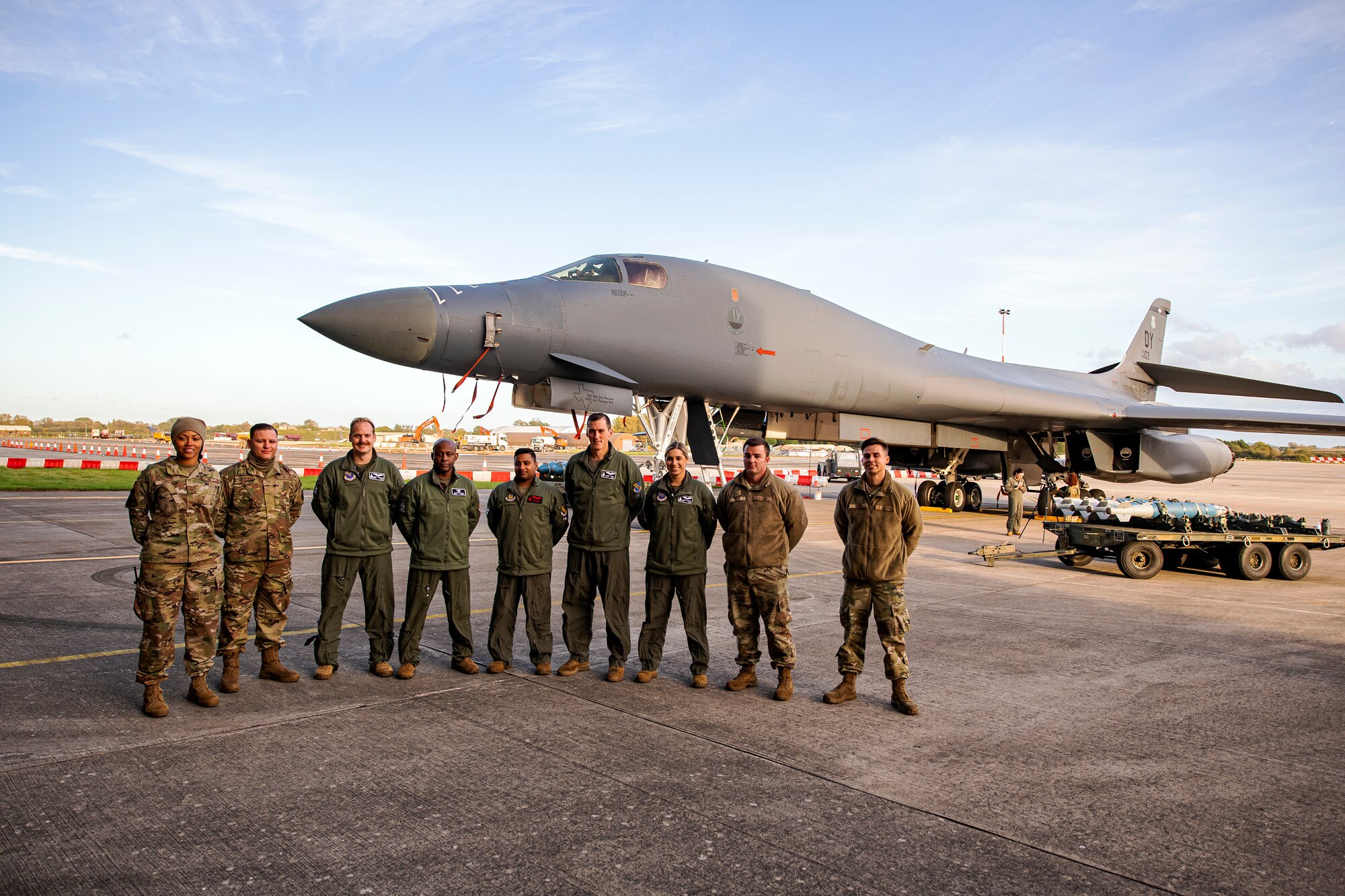 Airmen from the 9th Expeditionary Bomb Squadron pose for a photo following a Bomber Task Force press conference at RAF Fairford, England, Oct. 20, 2021. Airmen from the 9th EBS are temporarily stationed at RAF Fairford as part of a BTF deployment. A BTF is the global employment of U.S. strategic bombers, providing strategic military advantage to achieve national and combatant commander objectives. (U.S. Air Force photo by Senior Airman Eugene Oliver)