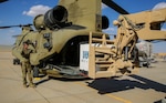 A U.S. soldier guides equipment onto a CH-47 Chinook, on Oct. 19, 2021. As equipment exits theater, Combined Joint Task Force-Operation Inherent Resolve remains ready and capable to deter threats while transitioning to an advise, assist and enable role in order to allow the continued defeat of Daesh.