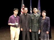 Photo of U.S. Army Soldier with his family on stage.