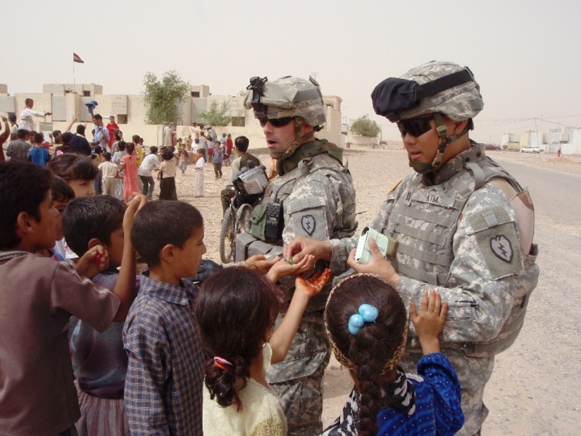 Photo of U.S. Army Soldiers talking with children in Afghanistan.