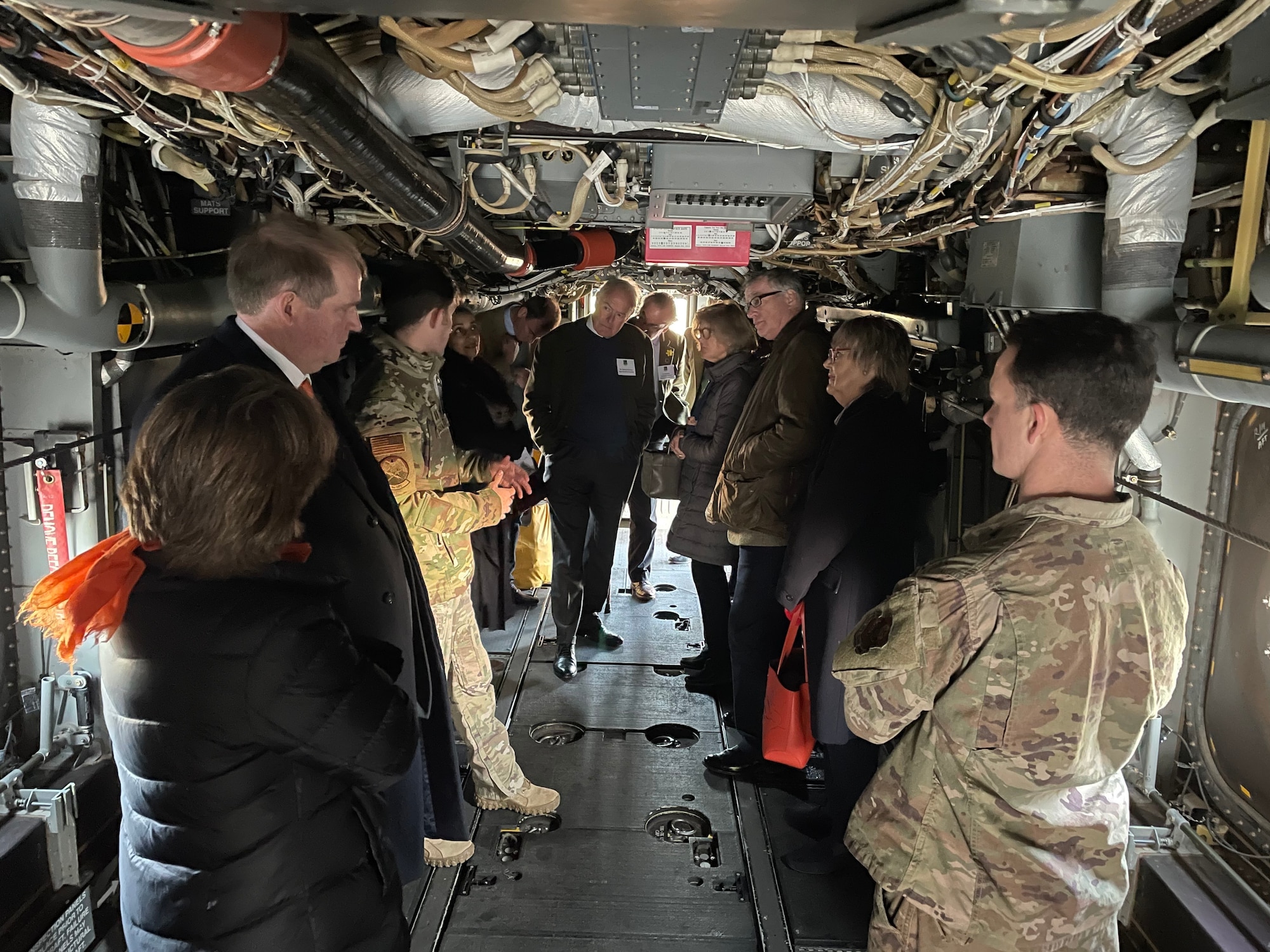 High sheriffs and deputy lieutenants from the Suffolk, Norfolk and Cambridgeshire counties of England listen to a briefing from Airmen assigned to the 352nd Special Operations Wing inside a CV-22B Osprey aircraft at Royal Air Force Mildenhall, England, Oct. 21, 2021. The high sheriffs and deputy lieutenants toured the base as part of a familiarization visit to learn about Team Mildenhall's mission sets and global impact. (U.S. Air Force photo by Senior Airman Joseph Barron)