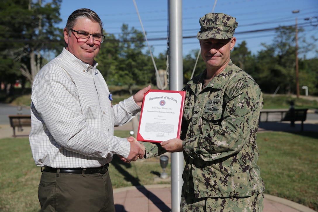 NSWC IHD Chief Learning Officer Stuart White receives a Commendation for Meritorious Civilian Service from NSWC IHD Commanding Officer Capt. Eric Correll during a presentation onboard the command, Oct. 18. (U.S. Navy photo by Ashli Jernigan)