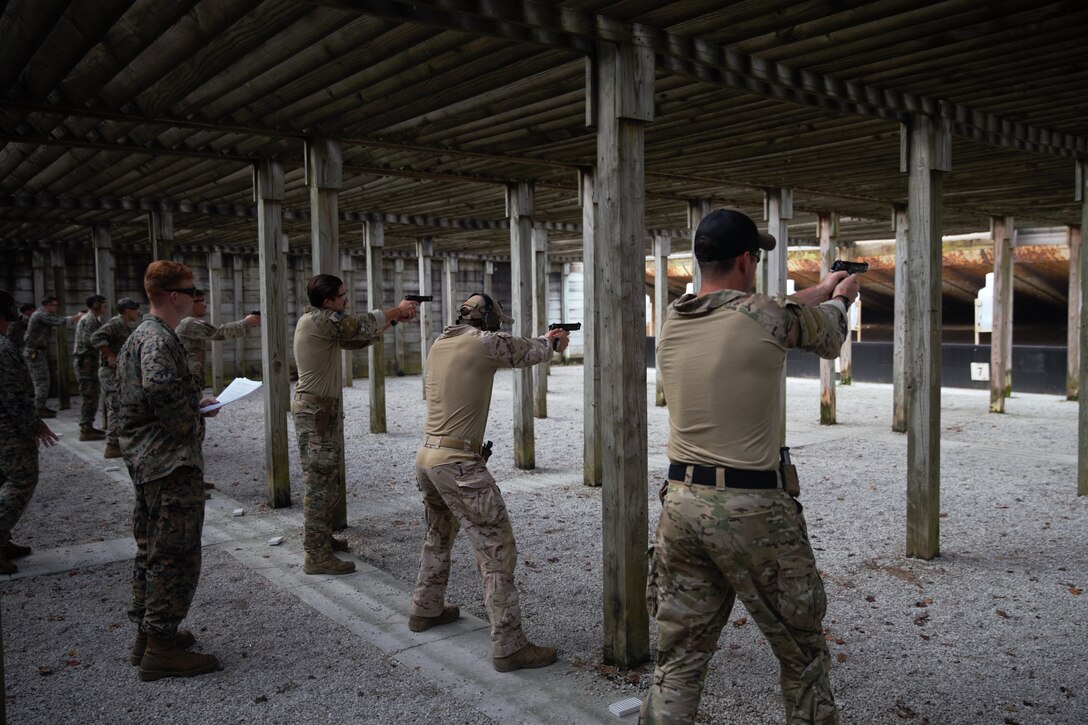 Members of the joint force participate in a pistol range during the East Coast EOD Team of the Year Competition on Camp Lejeune, North Carolina, Oct. 22, 2021. 8th Engineer Support Battalion hosted the competition to evaluate and assess technical expertise around the joint EOD community.
