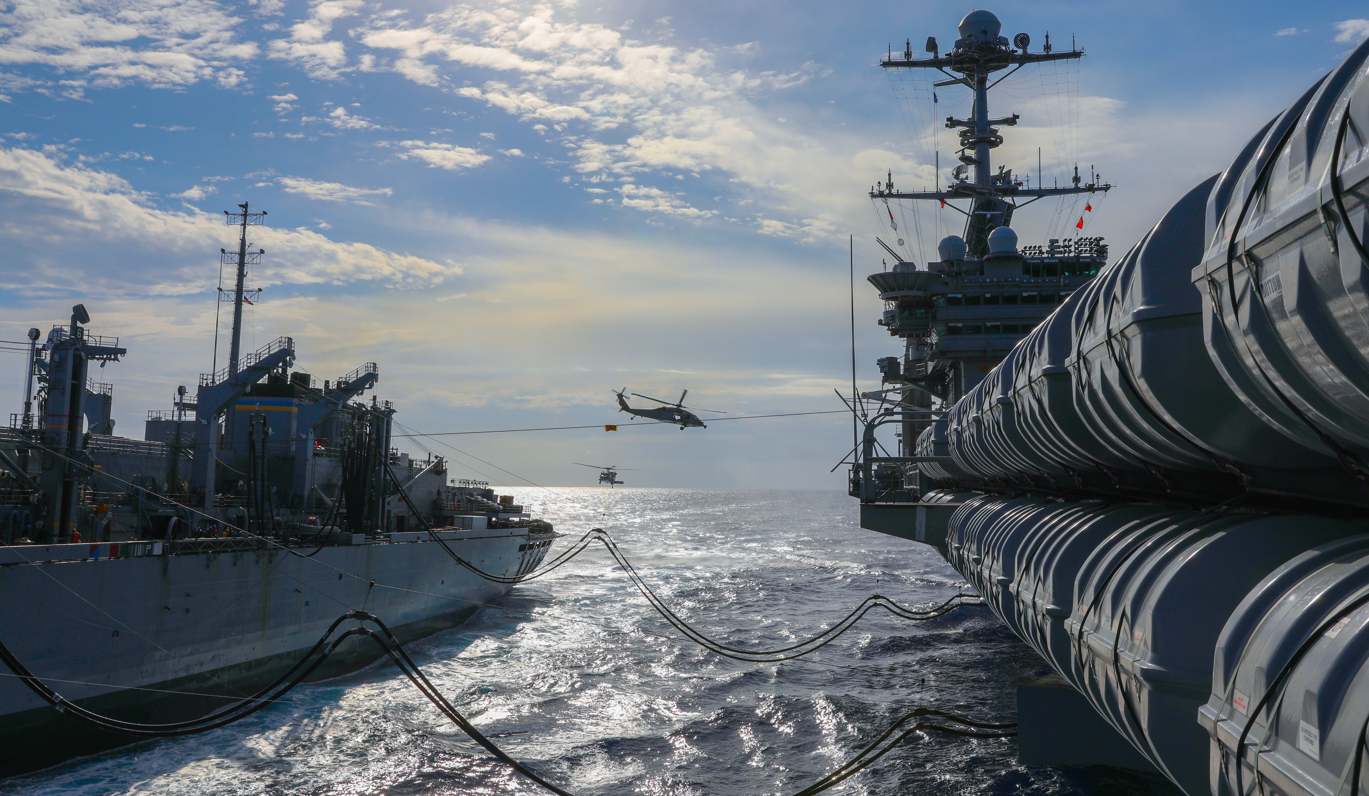 The fast combat support ship USNS Supply (T-AOE 6), left, transits alongside the Nimitz-class aircraft carrier USS Harry S. Truman (CVN 75) during a replenishment-at-sea.