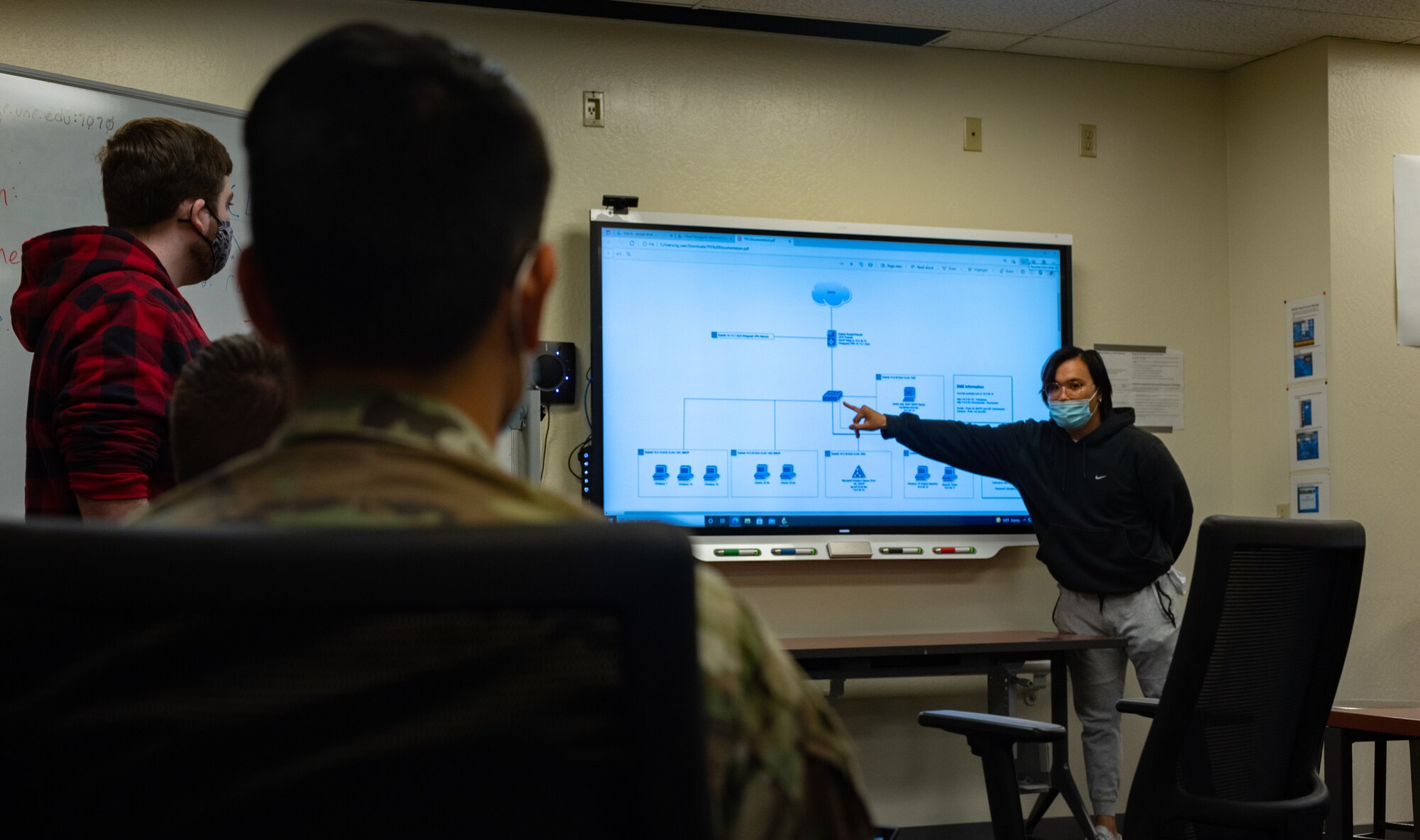 Samuel Gerard, University of Nevada, Reno (UNR) Cyber Club member and Nevada Cyber Range (NCR) developer, briefs members of the 152nd Communications Flight (CF), Nevada Air National Guard, on the technical layout of the NCR at the University of Nevada, Reno, Oct. 15, 2021. The 152nd CF and UNR’s Cyber Club have created a training partnership to develop both organizations’ cybersecurity skills.