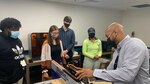 IMAGE: DAHLGREN, Va. (Oct. 22, 2021) – Eric Hayes (right), an information systems technician specialist with the NSWCDD Innovation Lab (iLab), explains a computer numerical control (CNC) machine to students from the da Vinci Center at Virginia Commonwealth University, during a tour of the iLab. The iLab empowers innovators to test ideas and solve naval warfare challenges. (U.S. Navy photo released)