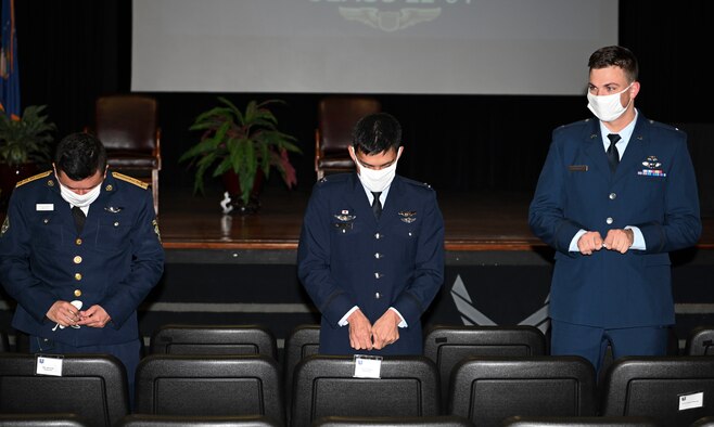 Graduates from Specialized Undergraduate Pilot Training class 22-01, break their first pair of wings, during their graduation ceremony, Oct. 22, 2021, on Columbus Air Force Base, Miss. During a long-standing aviation tradition, pilots will keep one half of the broken wings and give the second half to a loved one. The two halves are never to be brought back together while the pilot is still alive.  (U.S Air Force photo by Airman 1st Class Jessica Haynie)