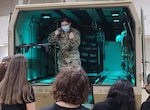 U.S. Army Sgt. Claire Johnson, a flight paramedic with C Company 3rd regiment 126th Aviation (Air Ambulance), provides explanations for medical equipment carried on the M997A3 ambulance to students in the health profession visiting Camp Johnson in Colchester, Vermont, Oct. 25, 2021. The Guard hosted students from the Center for Technology in Essex, VT.  (U.S. Army National Guard photo by Joshua T. Cohen)