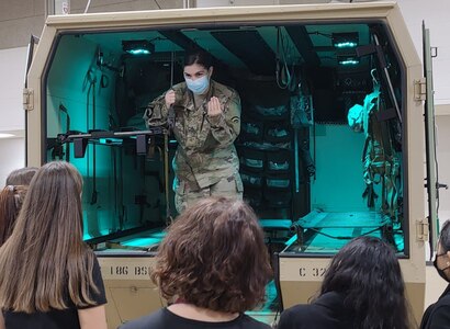 U.S. Army Sgt. Claire Johnson, a flight paramedic with C Company 3rd regiment 126th Aviation (Air Ambulance), provides explanations for medical equipment carried on the M997A3 ambulance to students in the health profession visiting Camp Johnson in Colchester, Vermont, Oct. 25, 2021. The Guard hosted students from the Center for Technology in Essex, VT.  (U.S. Army National Guard photo by Joshua T. Cohen)