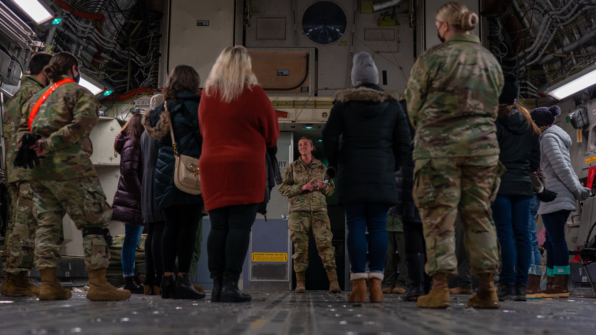 U.S. Air Force Staff Sgt. Morgan Hansen, 703rd Aircraft Maintenance Squadron C-17 Globemaster III aircraft flying crew chief, briefs 3rd Wing key spouses about a C-17 during an immersion at Joint Base Elmendorf-Richardson, Alaska, Oct. 14, 2021. The immersion gave key spouses an opportunity to see the 3rd Wing’s operations, educating and recognizing them as key components of the wing’s mission. (U.S. Air Force photo by Senior Airman Justin Wynn)