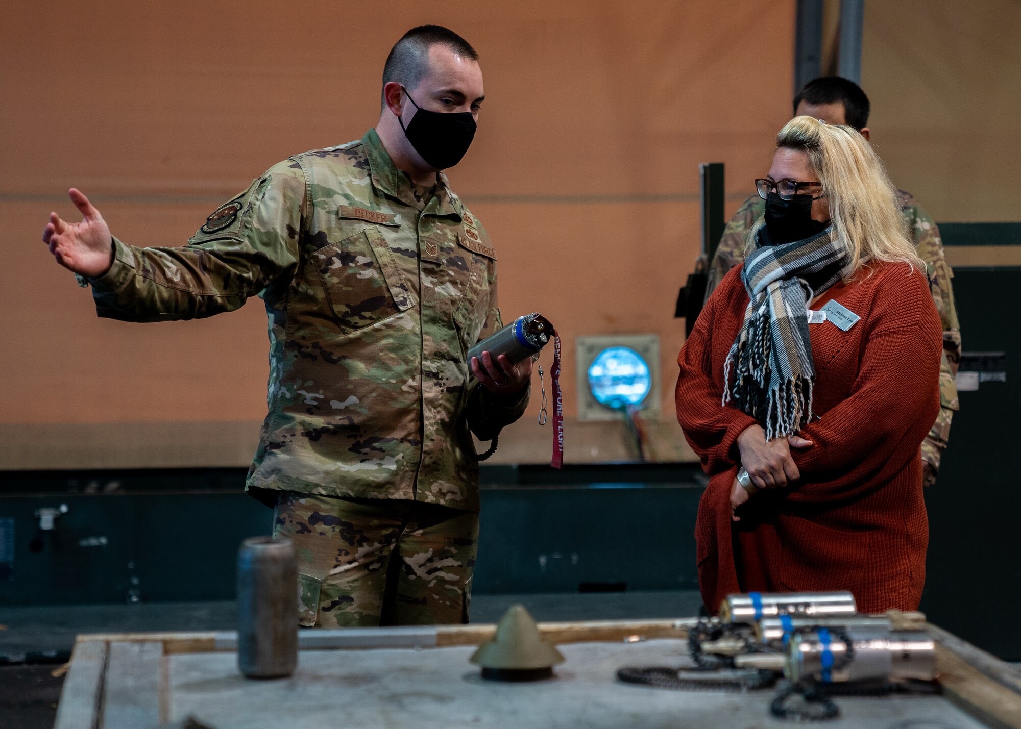 U.S. Air Force Tech. Sgt. Collin Becker, 3rd Munitions Squadron shop chief, plans and scheduling, explains munition components to Melissa Lea, 3rd Wing key spouse, during an immersion at Joint Base Elmendorf-Richardson, Alaska, Oct. 14, 2021. The immersion gave key spouses an opportunity to see the 3rd Wing’s operations, educating and recognizing them as key components of the wing’s mission. (U.S. Air Force photo by Senior Airman Justin Wynn)