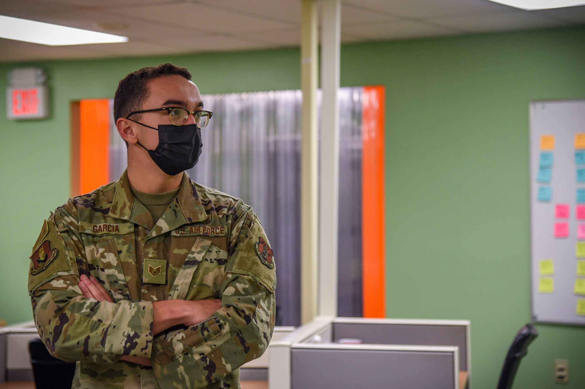 Staff Sgt. Eric Garcia, mission defense team member, 108th Communications Flight/ MDT, stands in the MDT work area and explains further the demand for cybersecurity professionals.