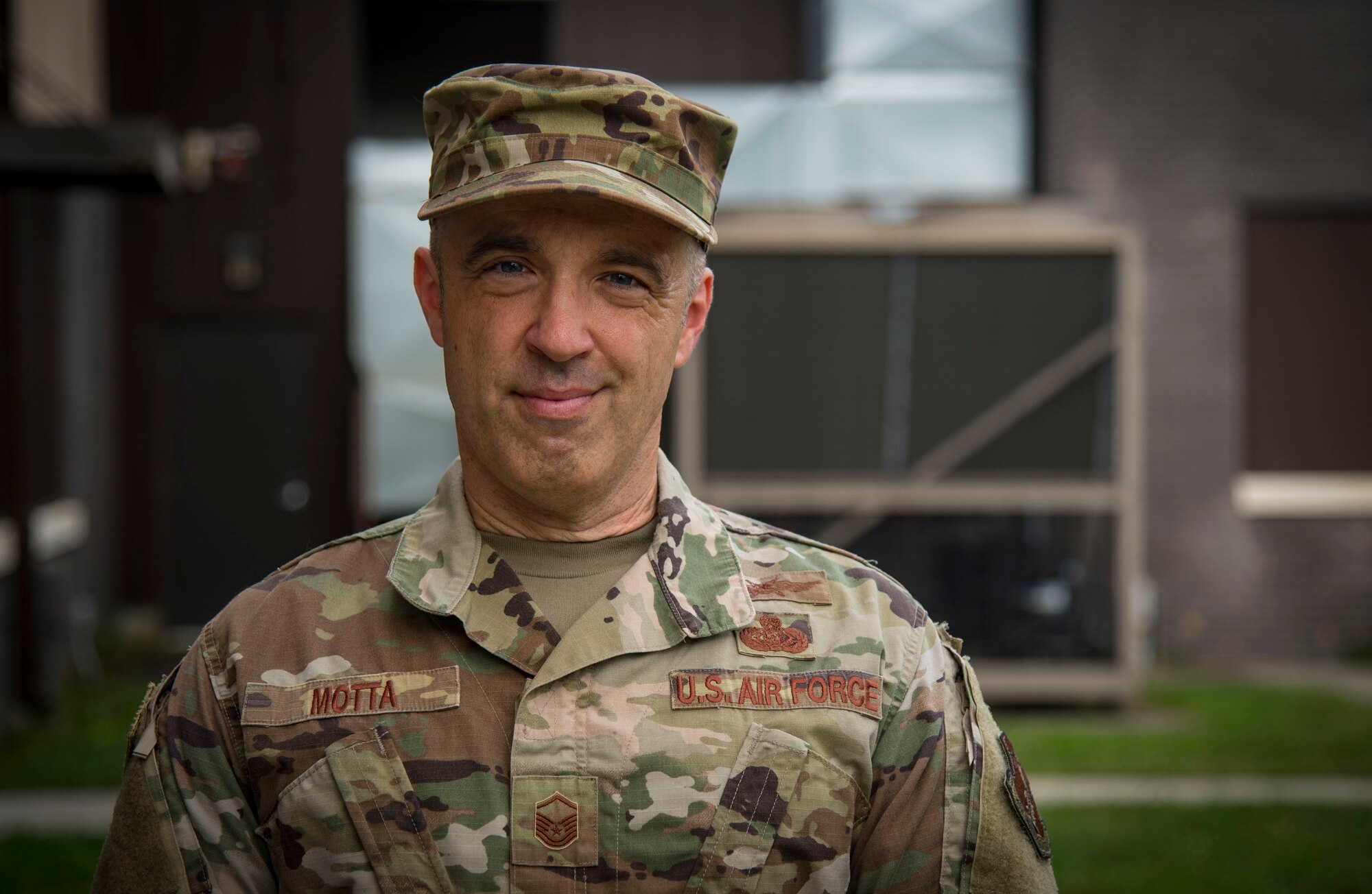 Master Sgt. Christopher Motta, non-commissioned officer-in-charge, 108th Communications Flight/ Mission Defense Team, poses for a portrait near the team's new work area.