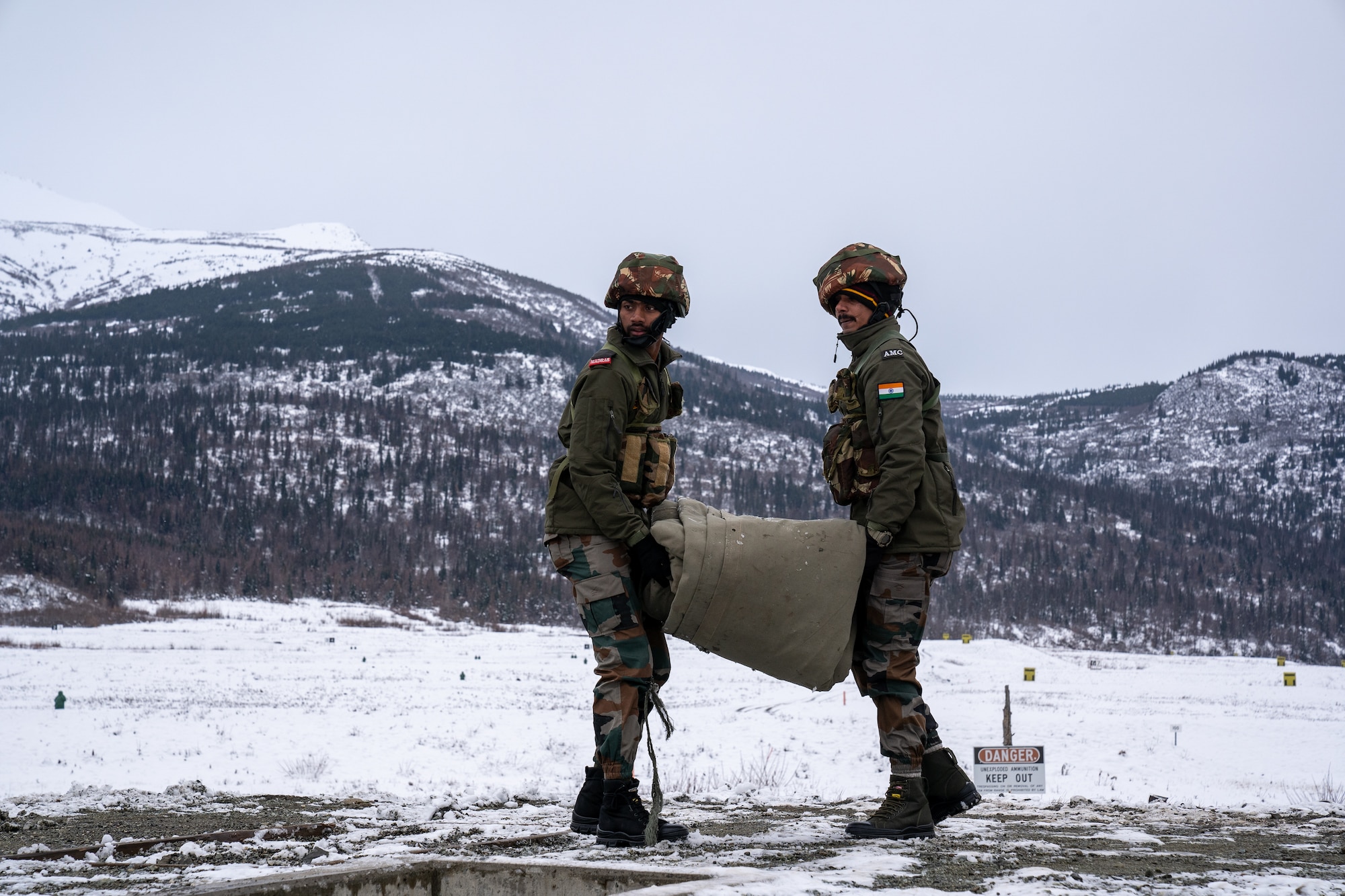 Indian Army troops from 7th Battalion, The Madras Regiment, “Shandaar Saath,” carry a tarp as they prepare for live-fire training during exercise Yudh Abhyas 21.