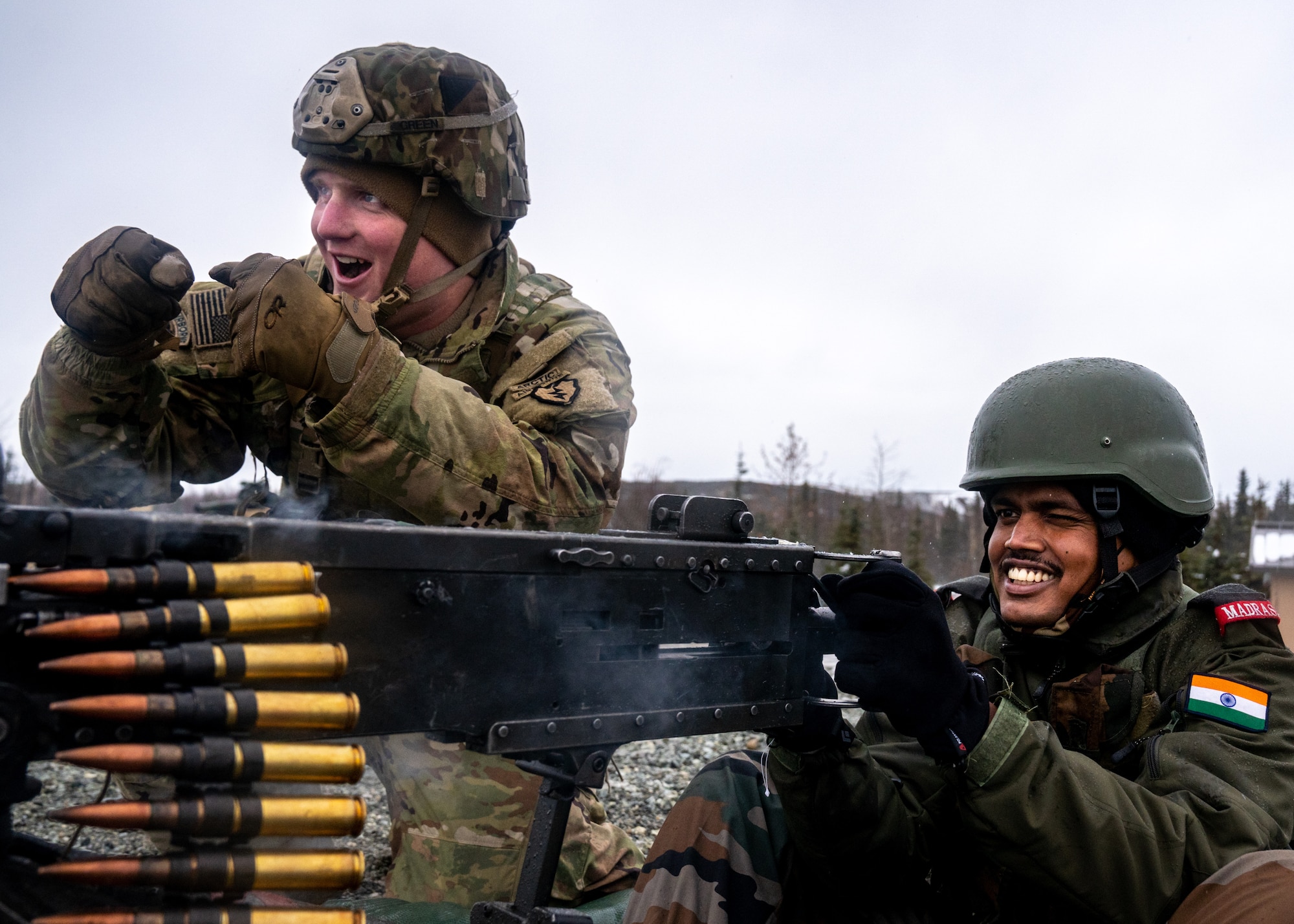 A U.S. Army paratrooper with the 4th Infantry Brigade Combat Team (Airborne), 25th Infantry Division, “Spartan Brigade,” and an Indian Army troop from 7th Battalion, The Madras Regiment, “Shandaar Saath,” fire a Browning M2 .50 Caliber Machine Gun during exercise Yudh Abhyas 21.