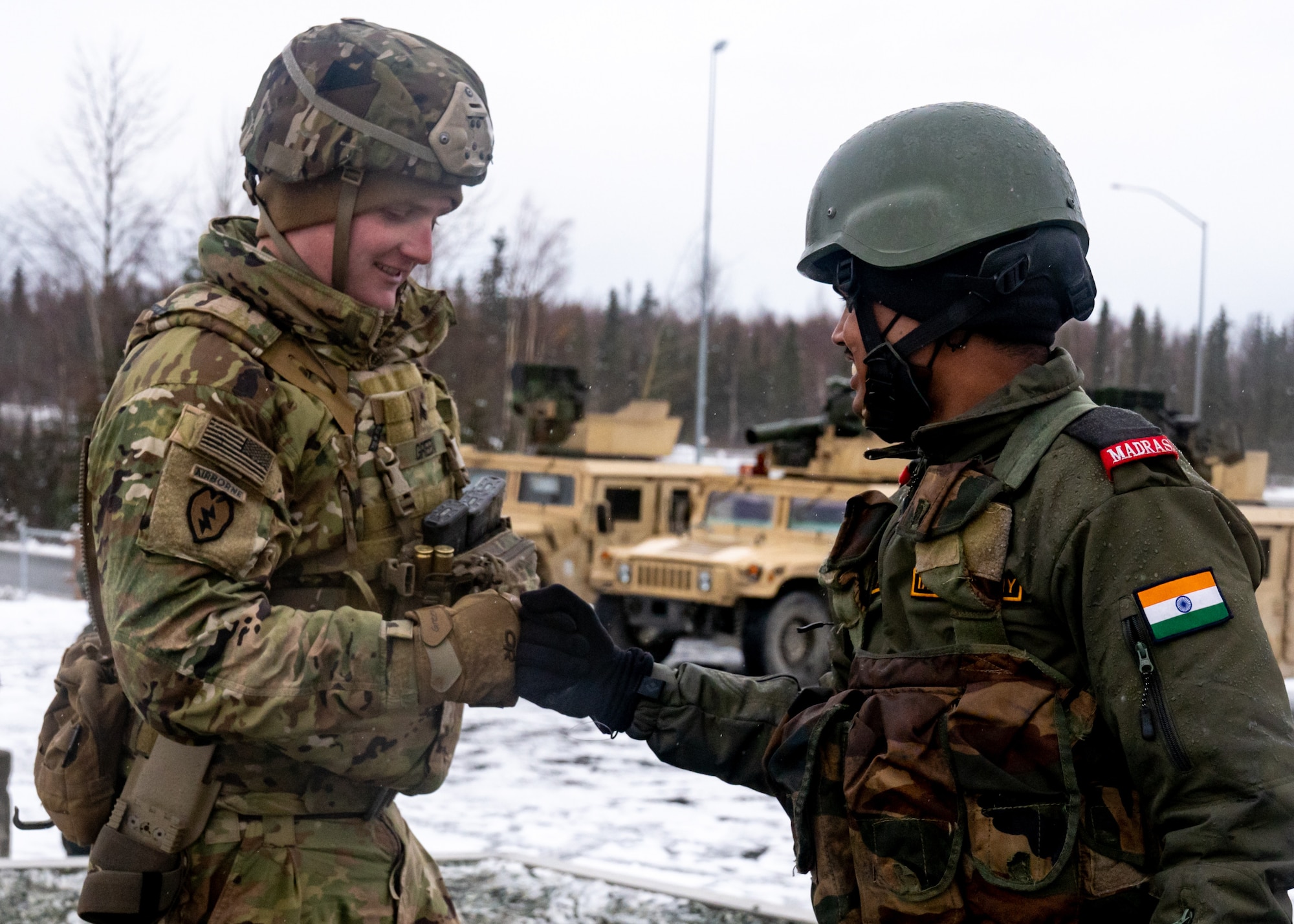 A U.S. Army paratrooper with the 4th Infantry Brigade Combat Team (Airborne), 25th Infantry Division, “Spartan Brigade,” and an Indian Army troop from 7th Battalion, The Madras Regiment, “Shandaar Saath,” congratulate each other after a successful training day during exercise Yudh Abhyas 21.