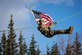 U.S. Army Staff Sgt. Schuyler Harvey, a paratrooper belonging to the 1st Squadron (Airborne), 40th Cavalry Regiment, 4th Infantry Brigade Combat Team (Airborne), 25th Infantry Division, carries the American flag as he descends from a rappel tower during exercise Yudh Abhyas 21.