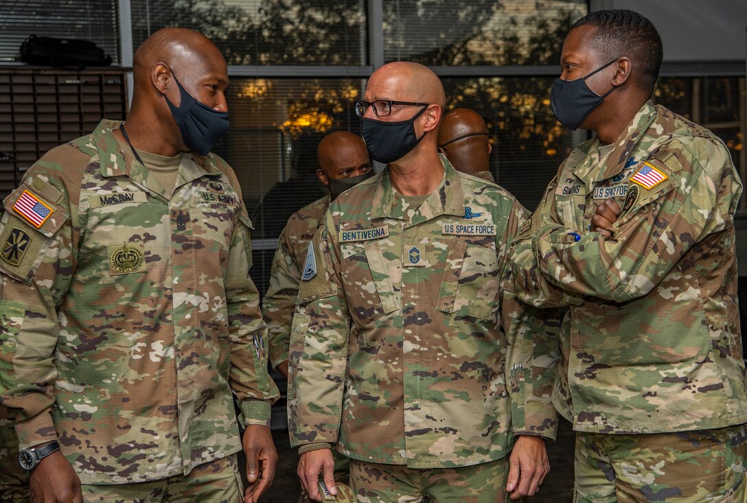 U.S. military senior enlisted leaders talk during a gathering at U.S. Space Command headquarters.