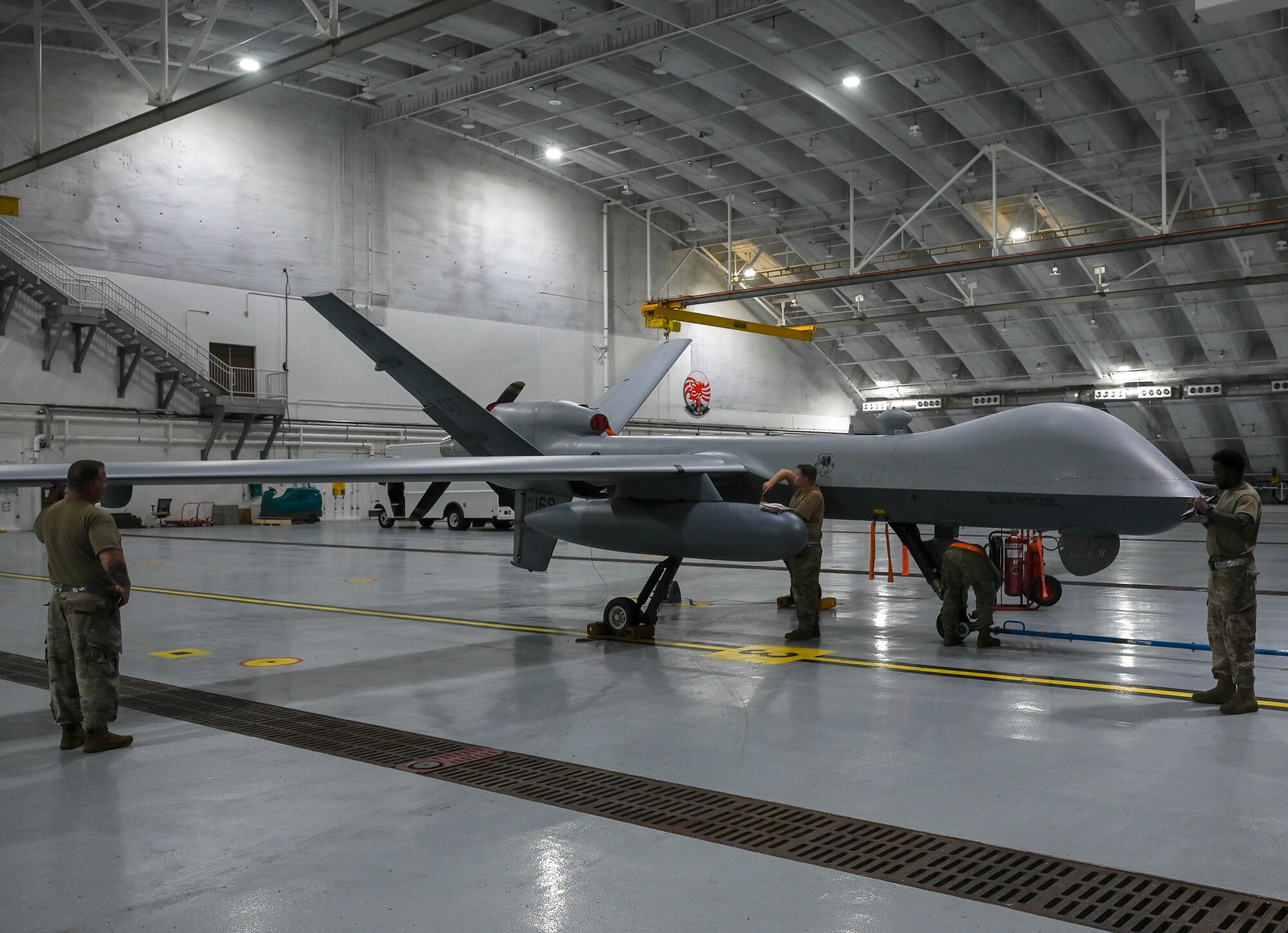 Airmen from the 556th Test and Evaluation Squadron preflight a MQ-9 Reaper at Andersen Air Force Base, Guam, Oct. 4, 2021.
