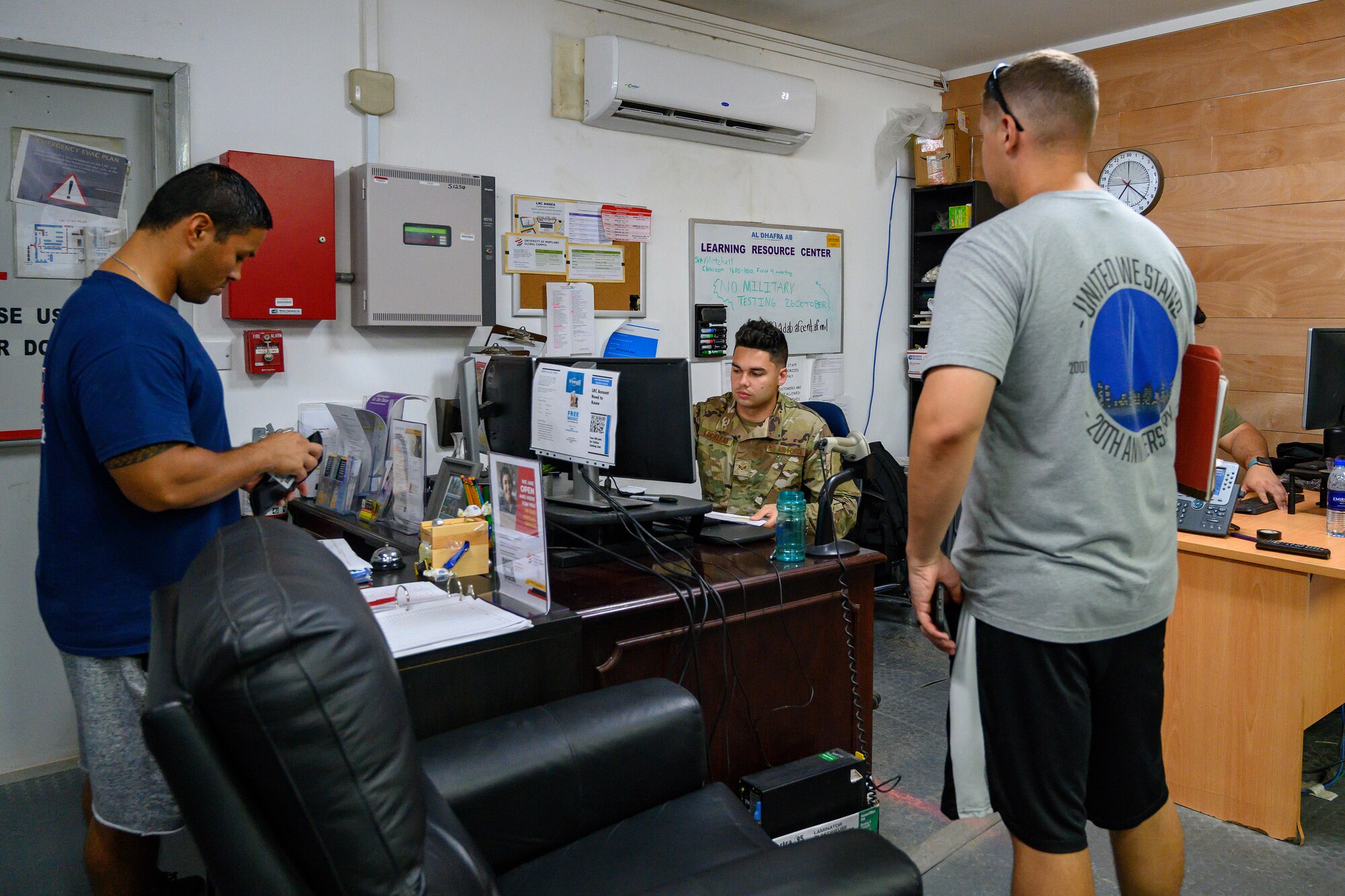 Three airmen in learning resource center