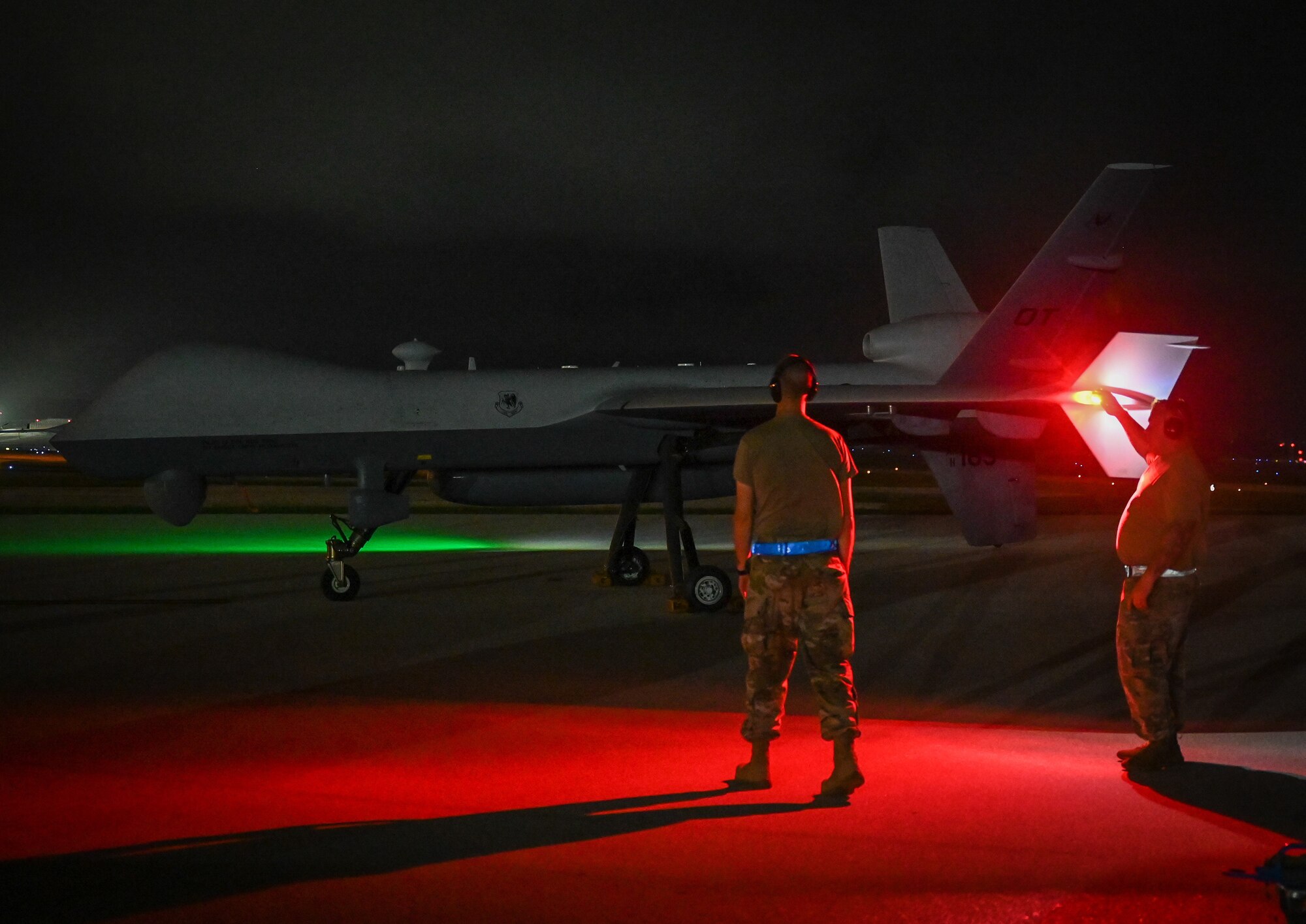 Airmen from the 556th Test and Evaluation Squadron preflight a MQ-9 Reaper at Andersen Air Force Base, Guam, Oct. 4, 2021.
