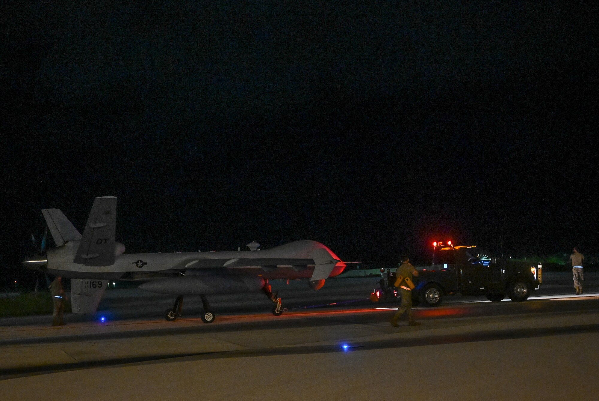 Airmen from the 556th Test and Evaluation Squadron preflight a MQ-9 Reaper at Andersen Air Force Base, Guam, Oct. 4, 2021.