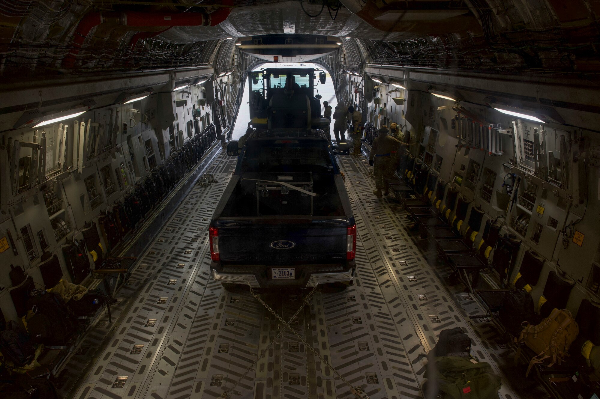 A truck and a 10K all-terrain forklift are loaded onto a C-17 Globemaster III during the Nodal Lightning exercise at Ted Steven International Airport in Anchorage, Alaska, Oct. 19, 2021. The Nodal Lightning exercise allowed the 732nd AMS personnel to respond efficiently and effectively to contested or degraded contingency environments.