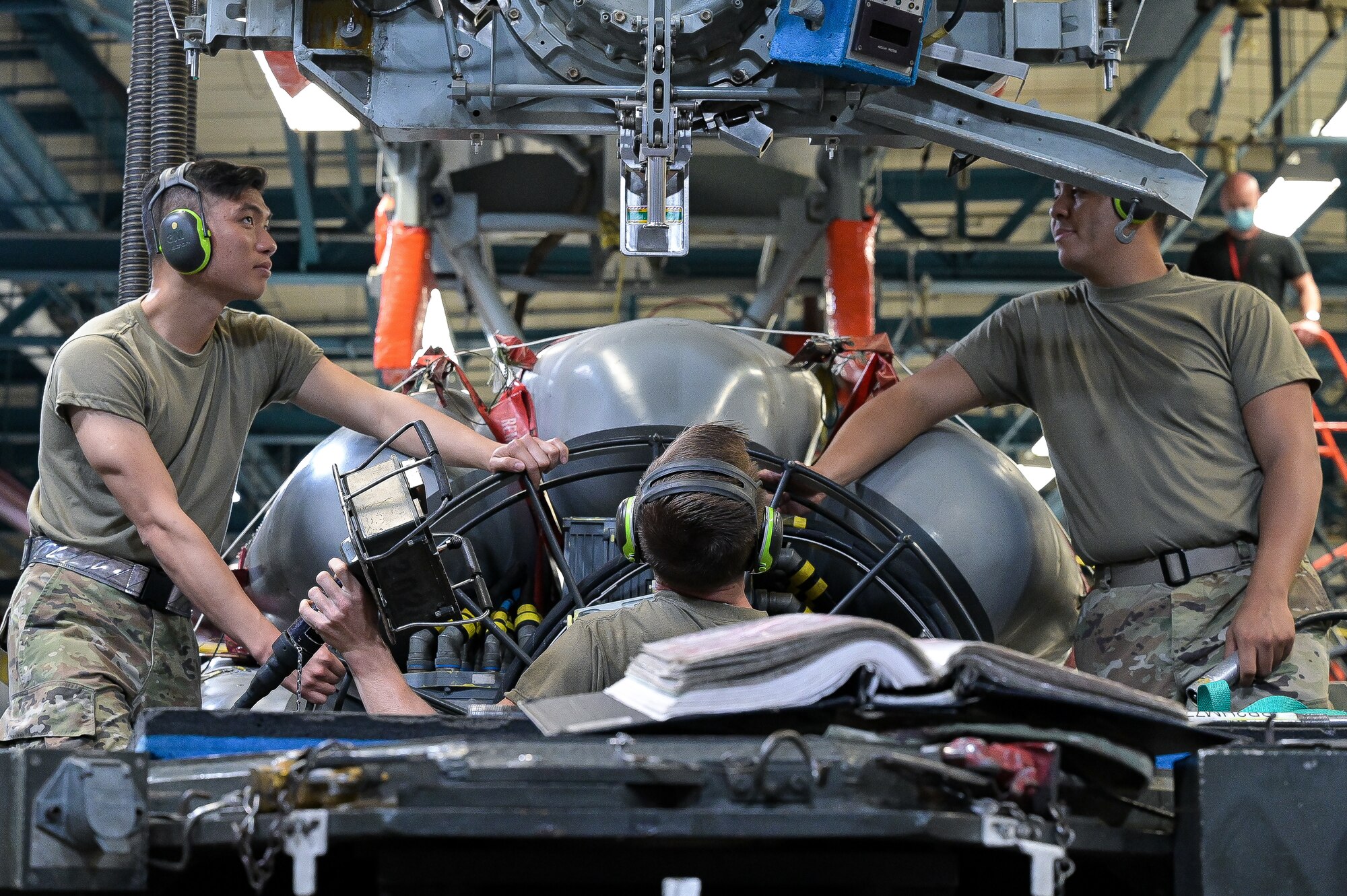 Airman 1st Class, Paxton Liu, left, 2nd Munitions Squadron weapons maintenance team member, Senior Airman Dakota Johnston, middle, 2nd MUNS weapons maintenance team member, and Senior Airman Michael Captain, right, 2nd MUNS weapons maintenance team chief, conduct maintenance on an Air-launched Cruise Missile at Barksdale Air Force Base, Louisiana, Oct. 20, 2021. The exercise was conducted to observe the readiness capabilities of Airmen during a real life scenario. (U.S. Air Force photo by Airman 1st Class Jonathan E. Ramos)