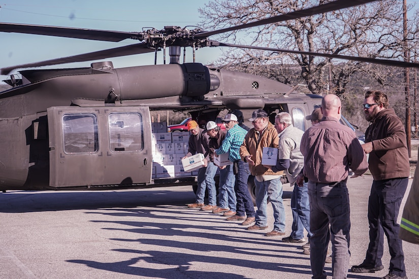 Equipment that includes hard hats, hoses and rakes are atop a platform.